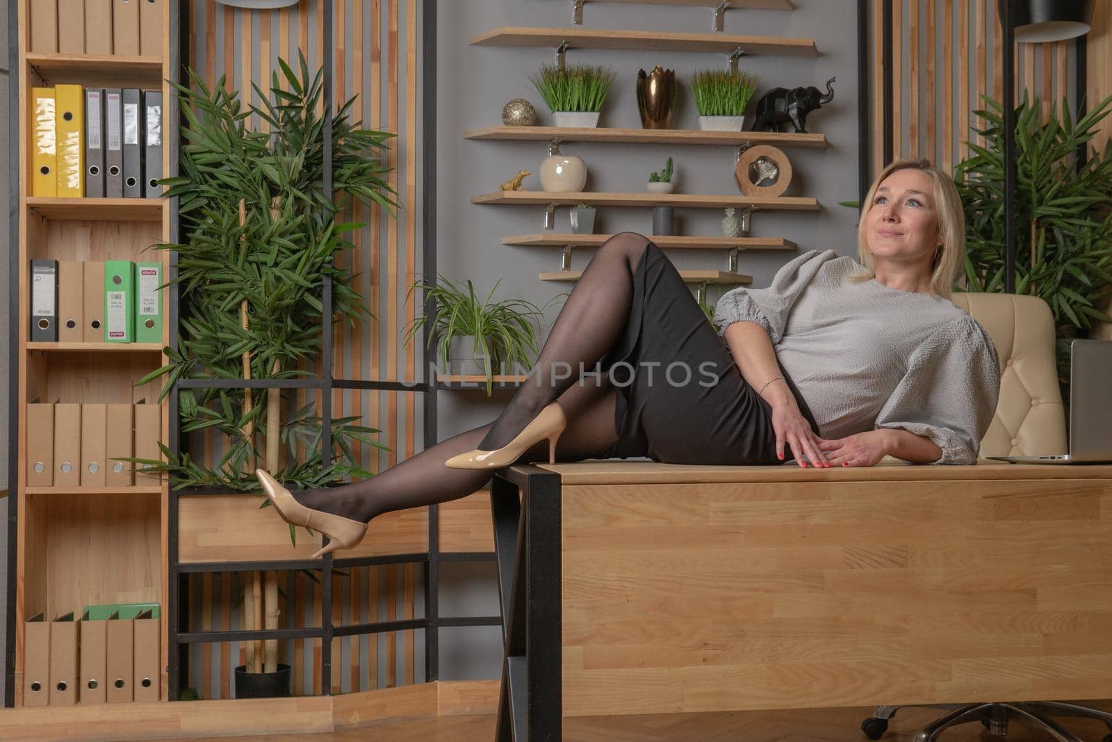 Sits on the edge of the table woman table female office desk, from businesswoman lifestyle for workplace smile worker, sitting computer. Technology beautiful home, successful