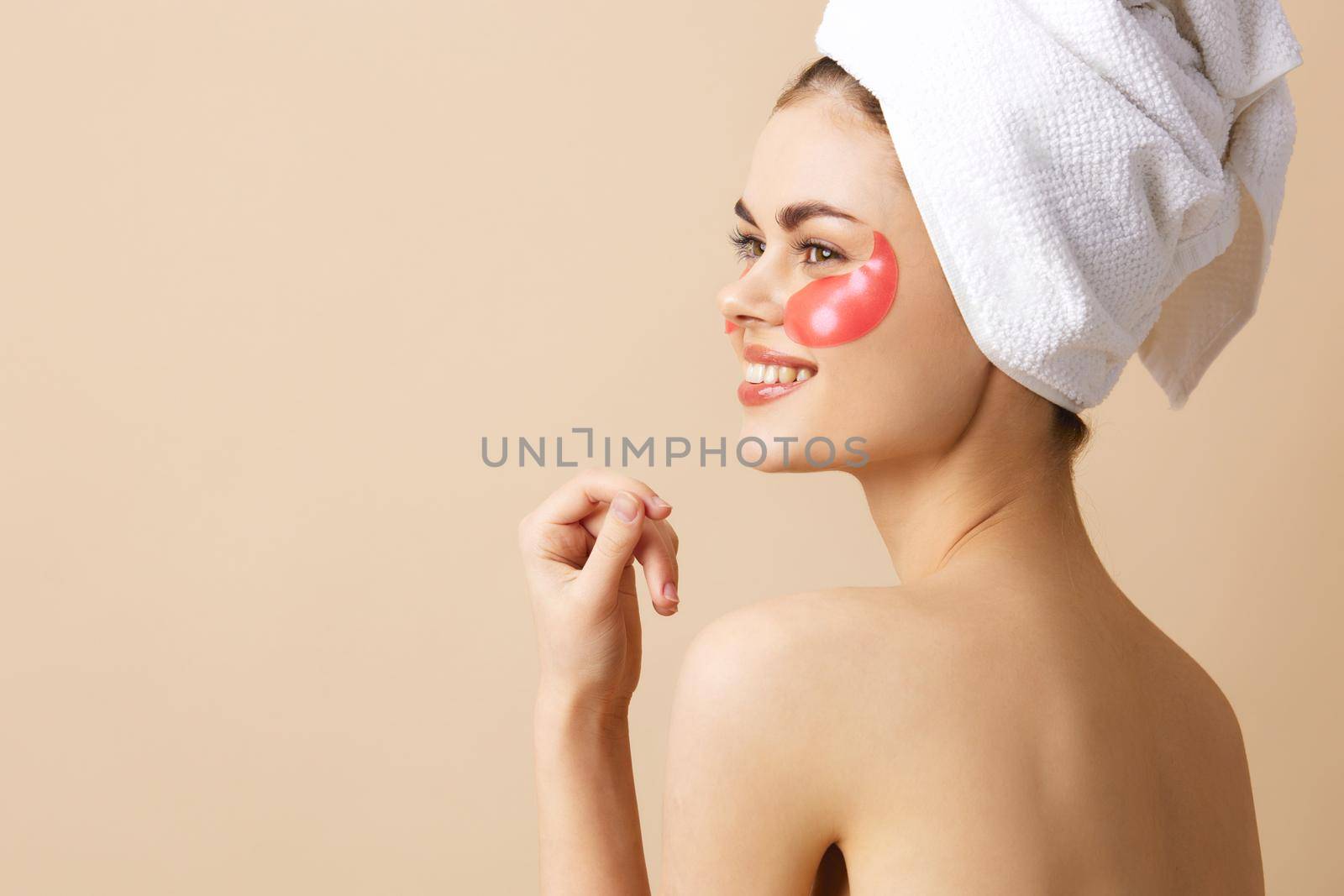 pretty woman with a towel on his head gesturing with his hands skin care close-up Lifestyle by SHOTPRIME