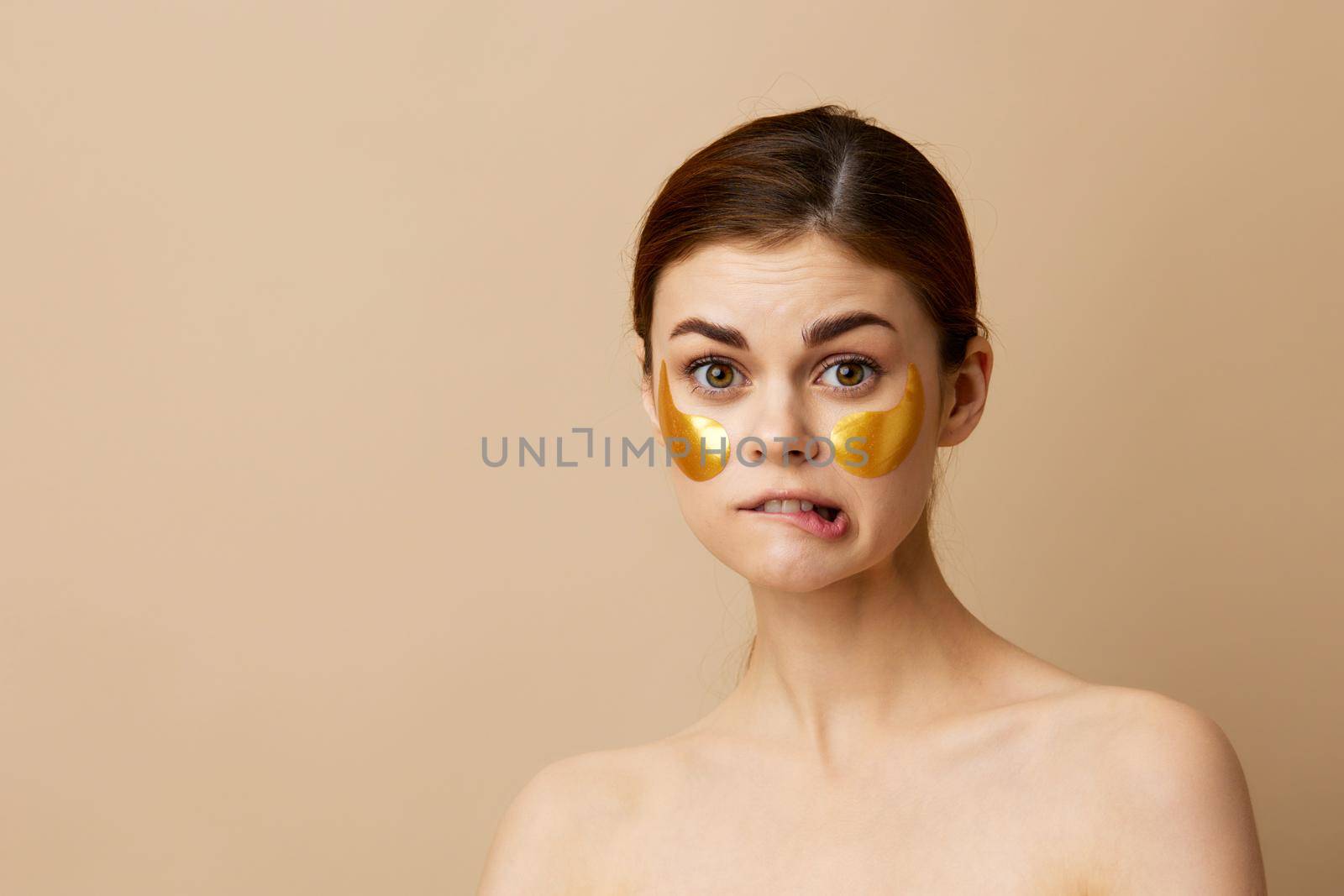 beautiful woman patches rejuvenation skin care fun after shower beige background. High quality photo