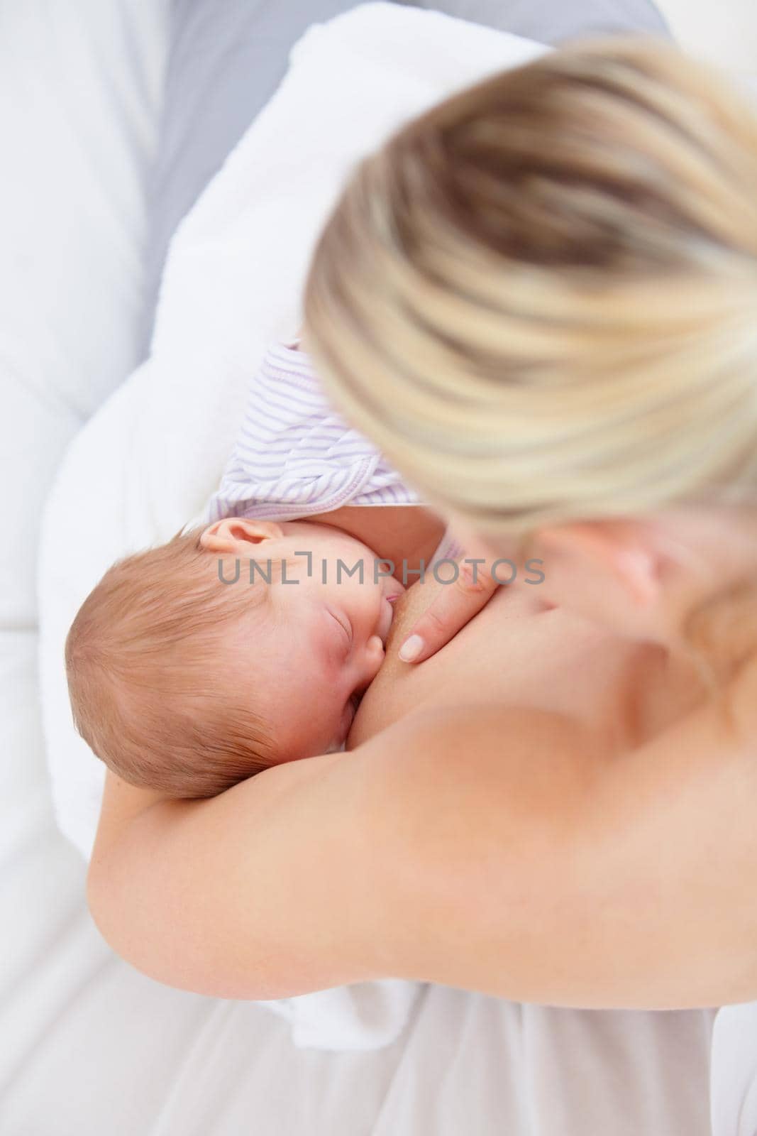 High angle shot of a mother breastfeeding her newborn baby.