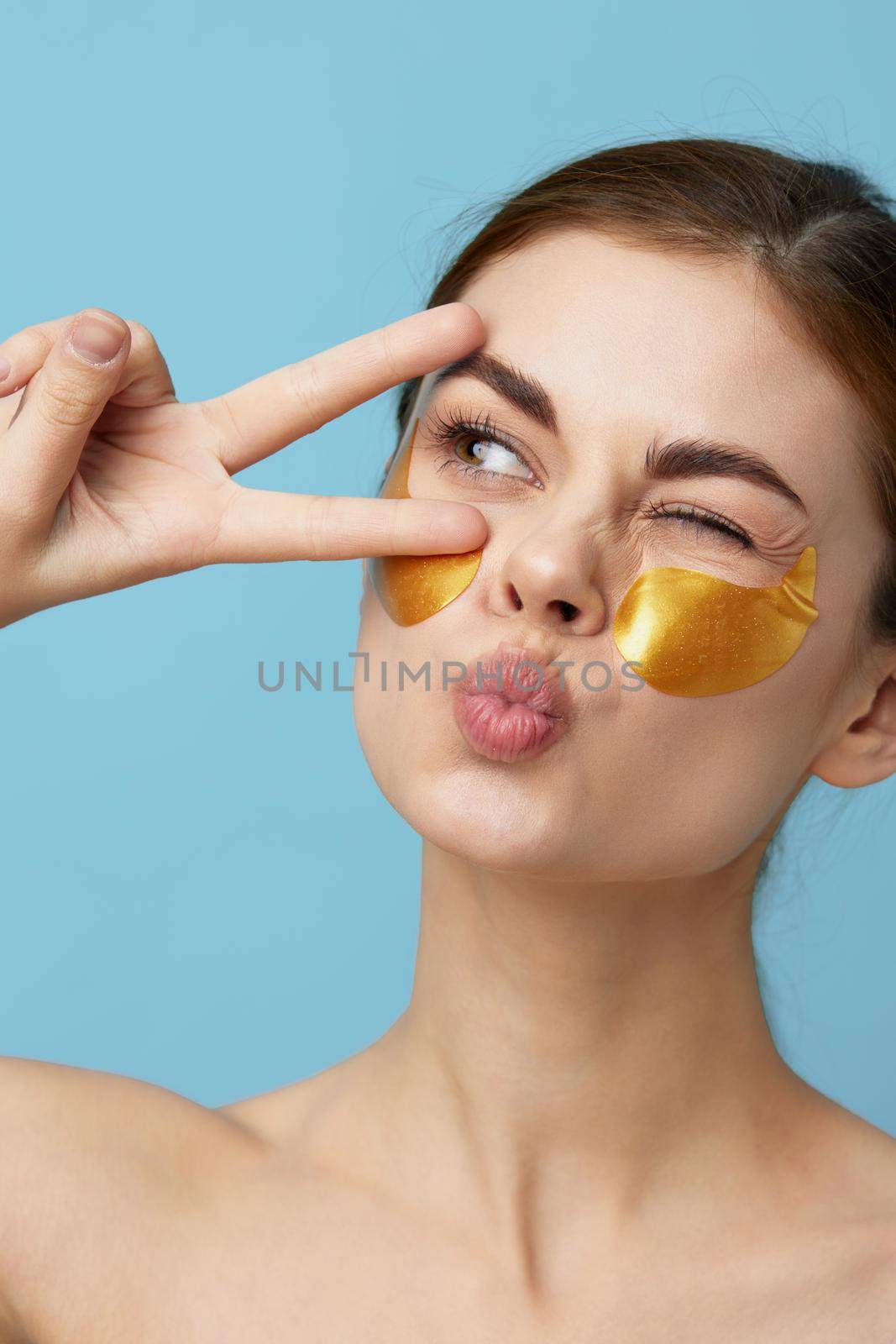 young woman skin care face patches bare shoulders hygiene isolated background. High quality photo