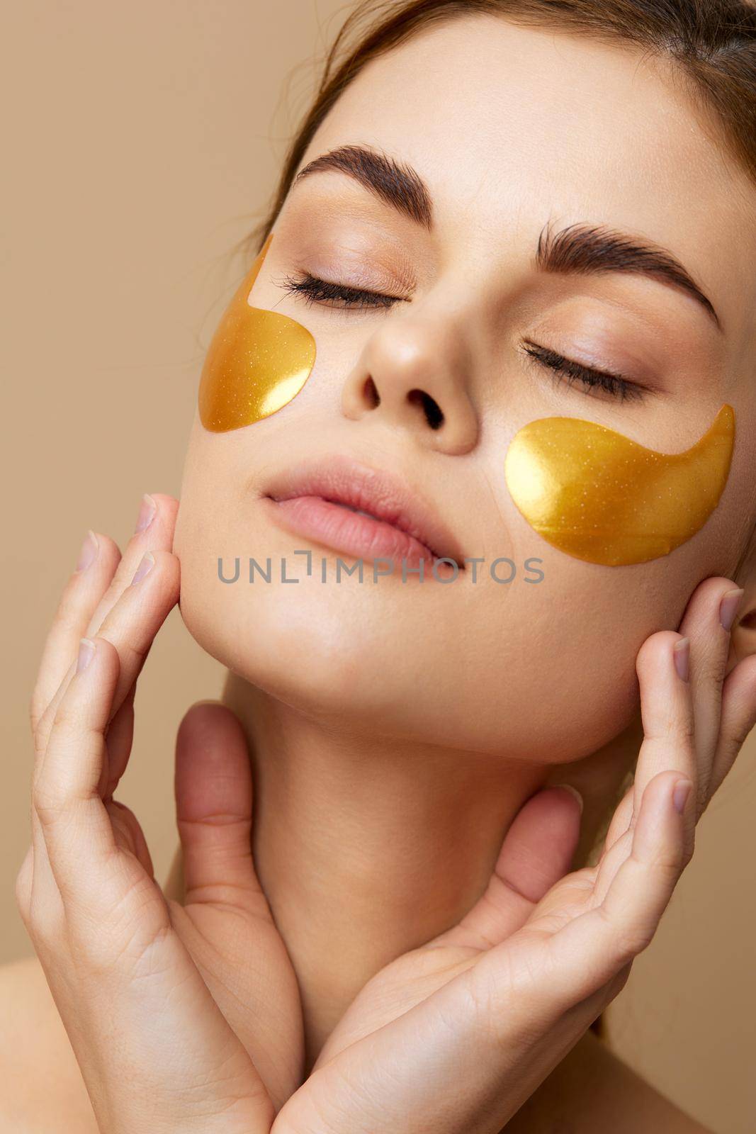 portrait woman golden patches on the face with a towel on the head isolated background by SHOTPRIME