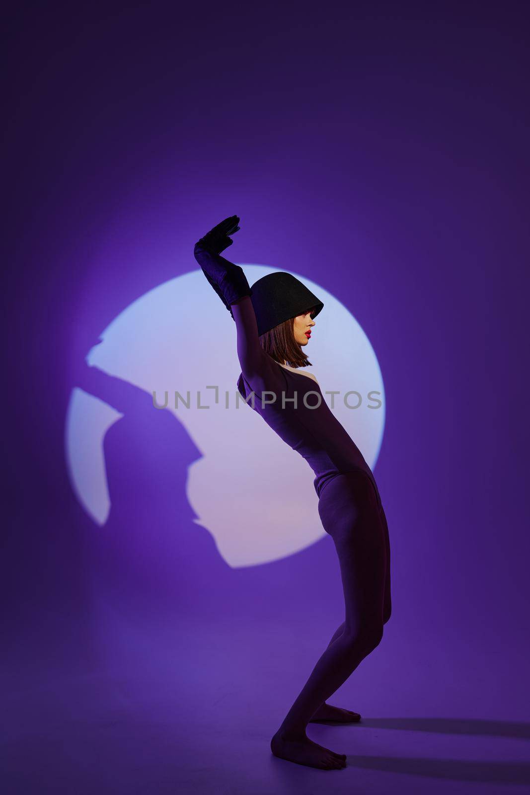 glamorous woman posing on stage spotlight silhouette disco color background unaltered by SHOTPRIME