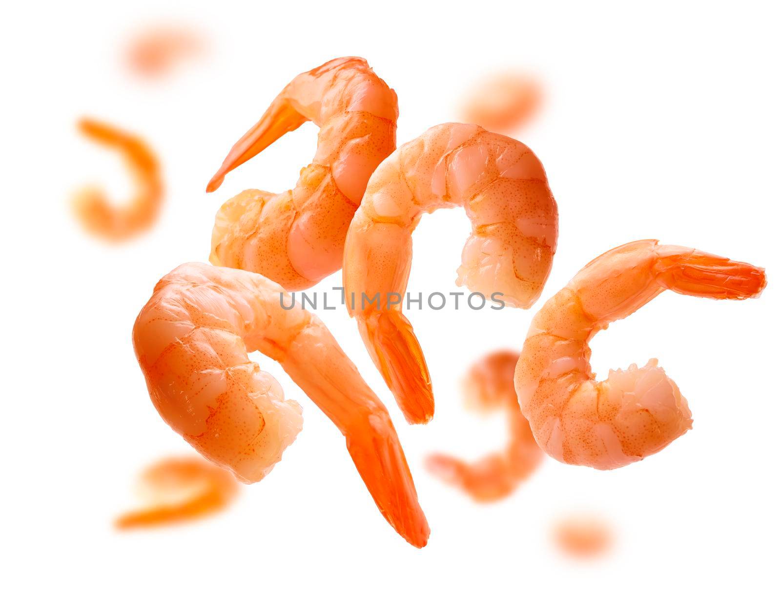 Boiled prawns levitate on a white background.