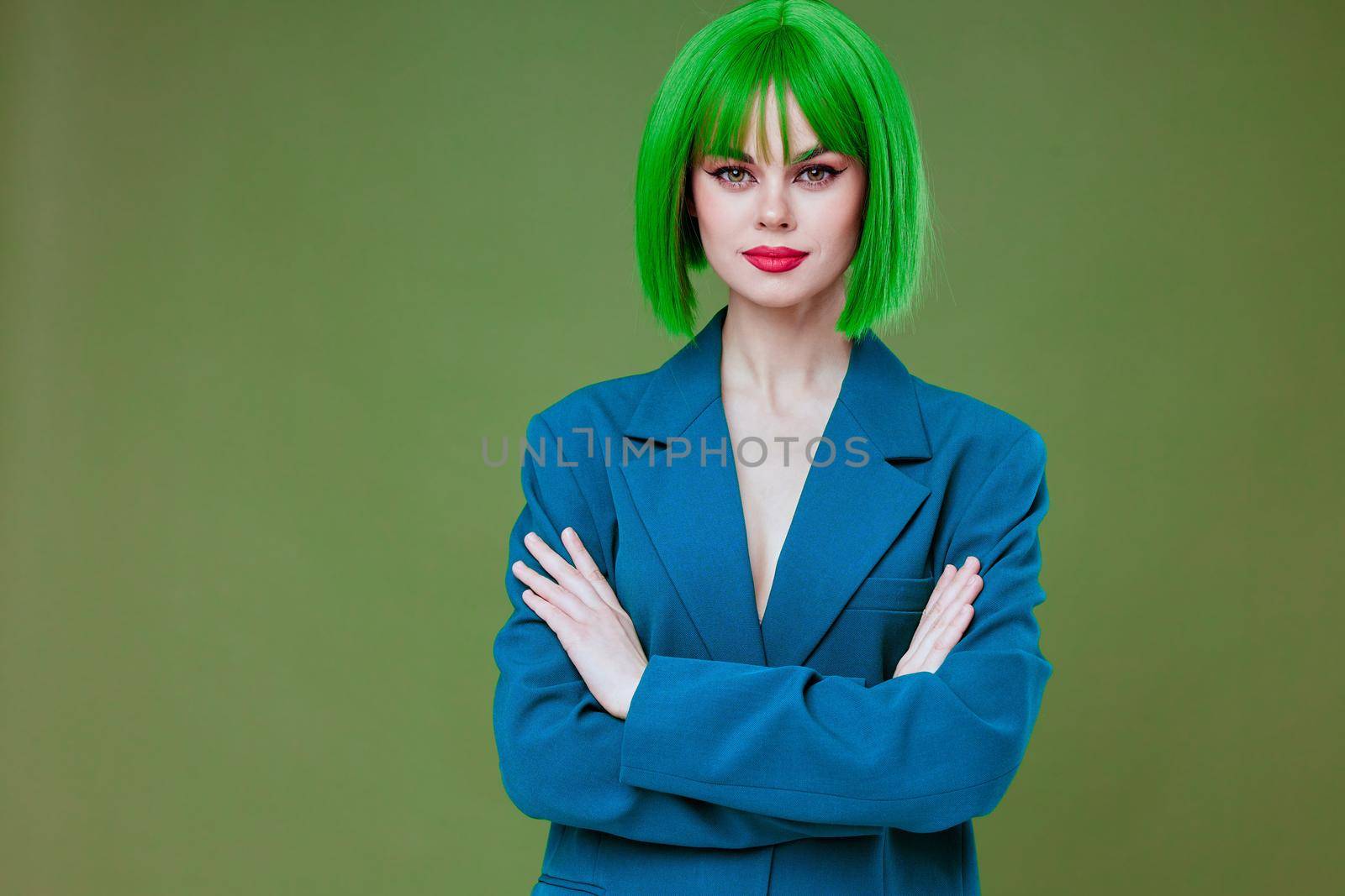 Pretty young female attractive look green wig blue jacket posing green background unaltered by SHOTPRIME