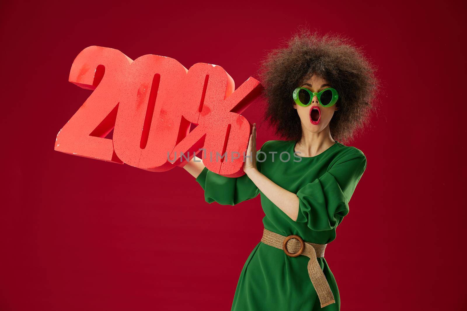 Pretty young female holding red twenty percent discount advertising color background unaltered. High quality photo