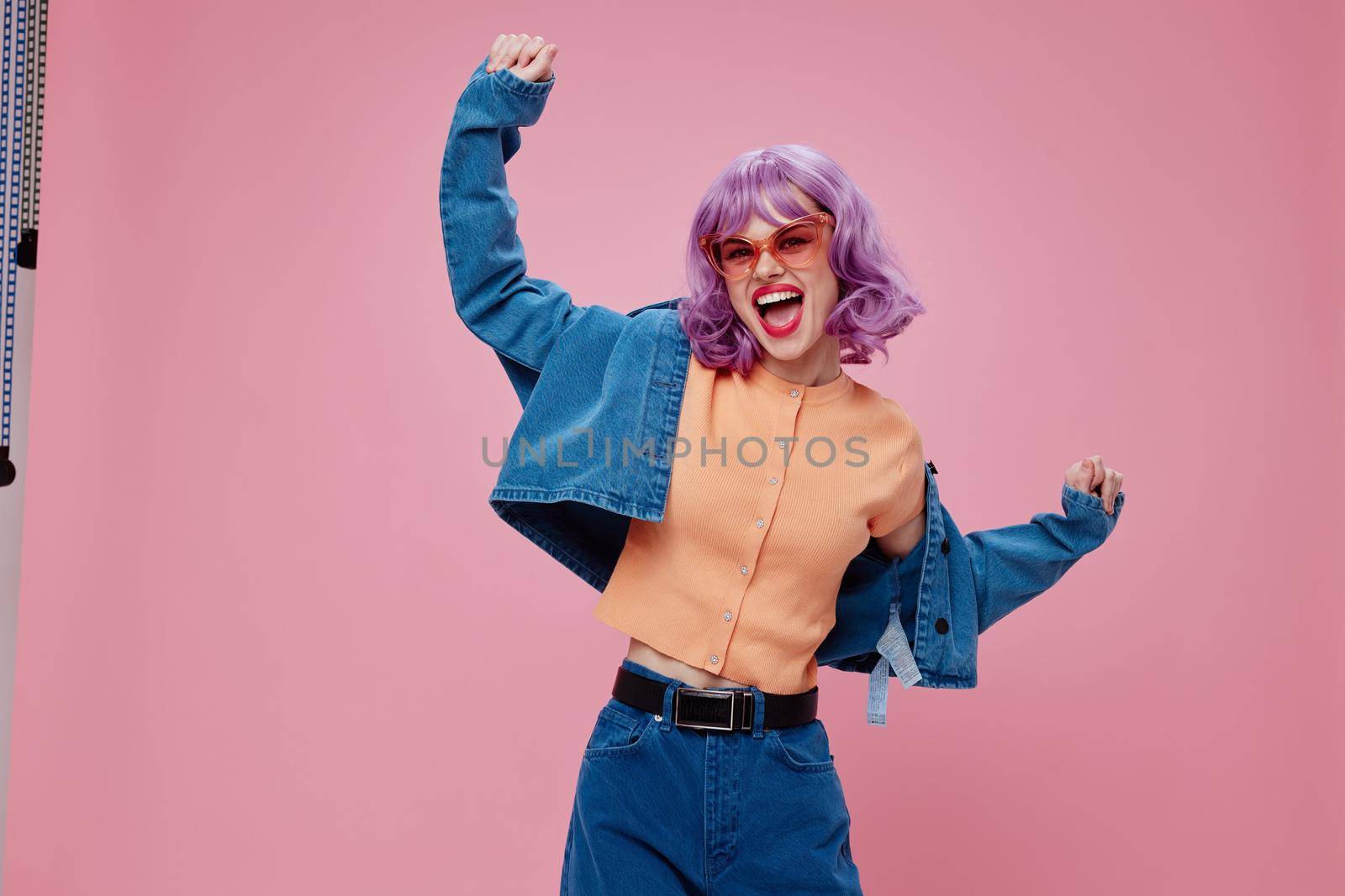 Beautiful fashionable girl purple hairstyle red lips denim jacket fun pink background unaltered by SHOTPRIME