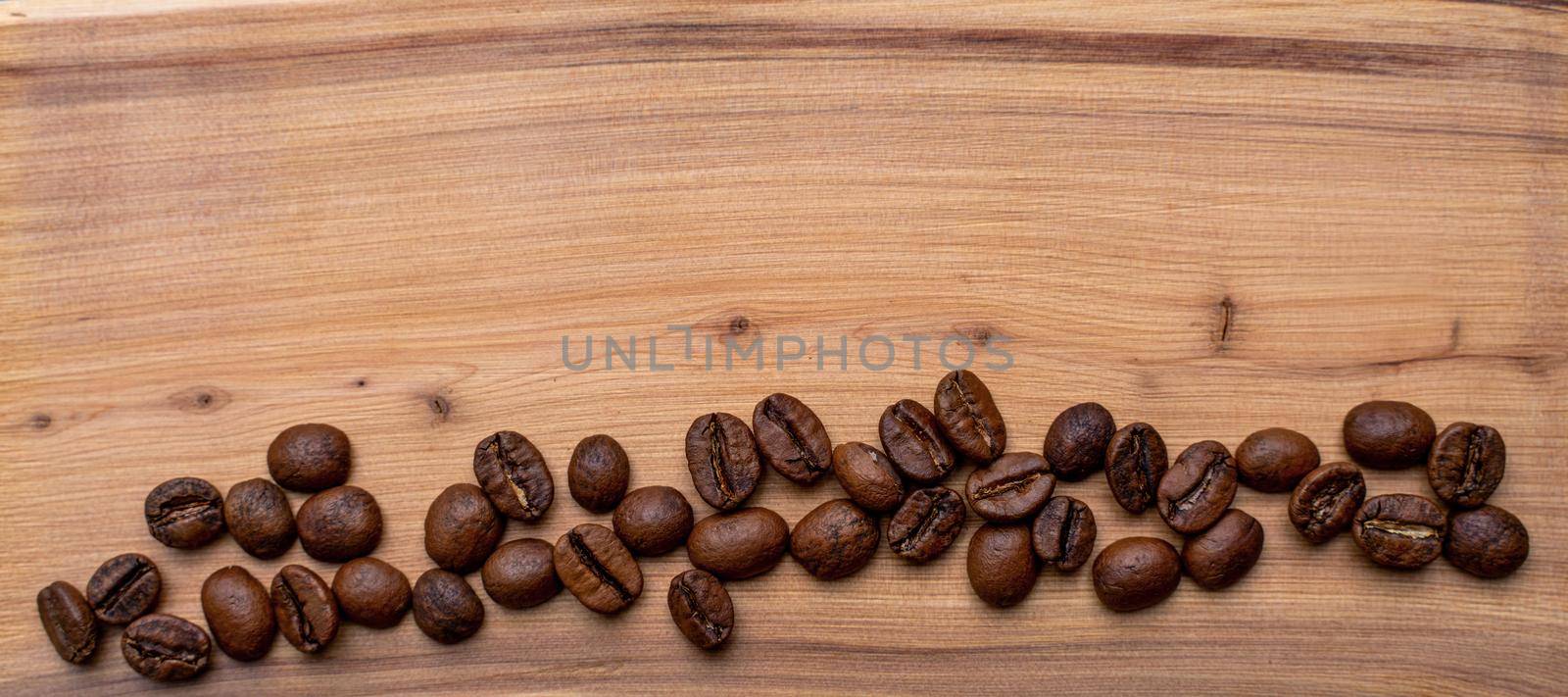 Coffee beans on a wooden background banner, place for the inscription. by Matiunina
