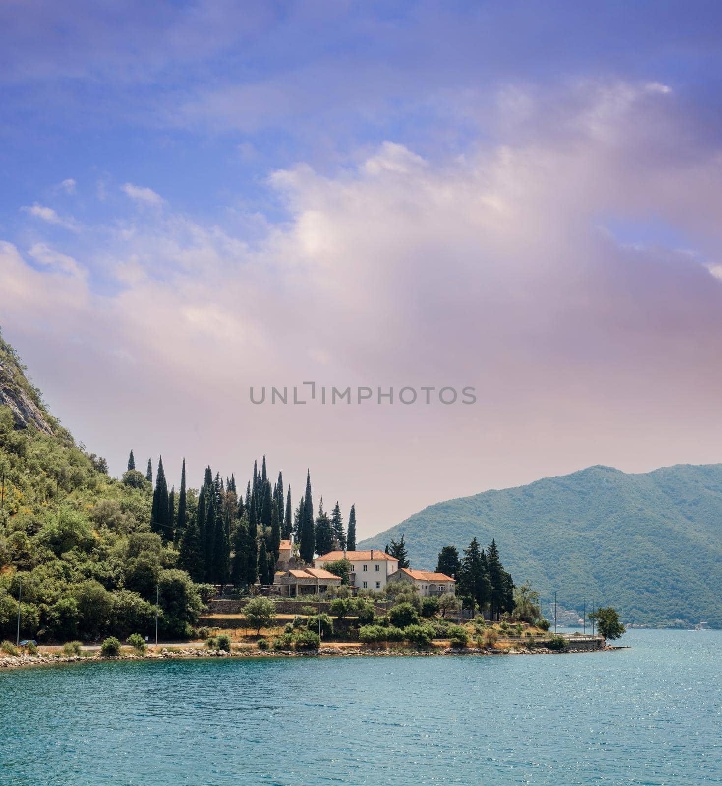 Blue boat in Bay of Kotor of Adriatic Sea, Montenegro. Beautiful view of the natural landscape. shore of Kotor. Scenic summer resort landscape. summer rest, vacation.