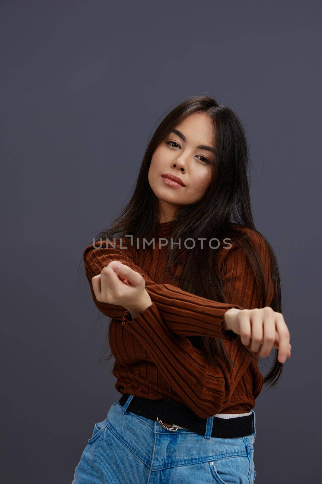 beautiful woman hand gestures brown sweater fashion Gray background by SHOTPRIME