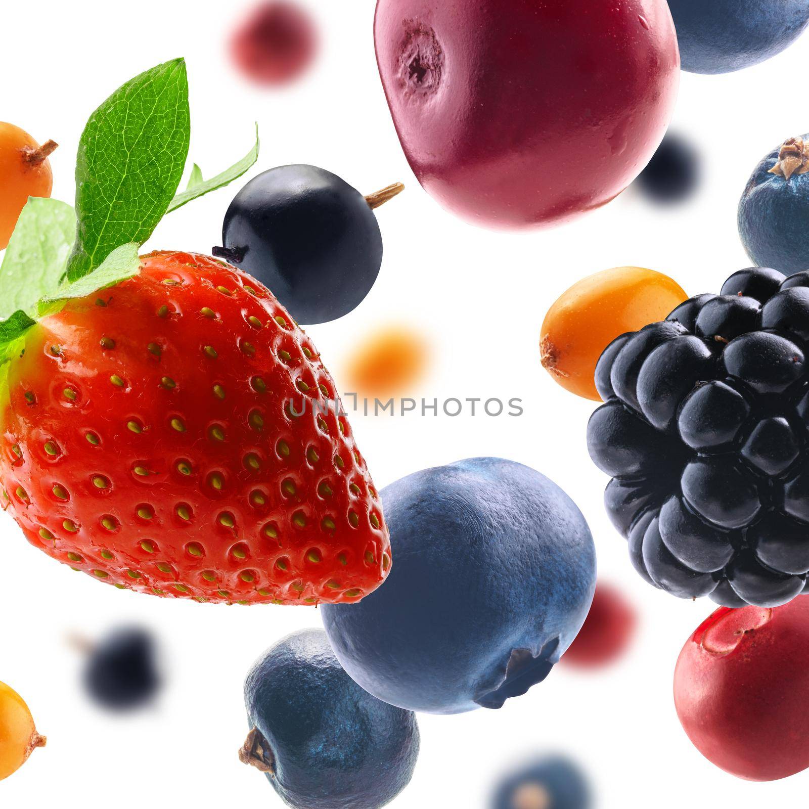 Many different berries in the form of a frame on a white background.