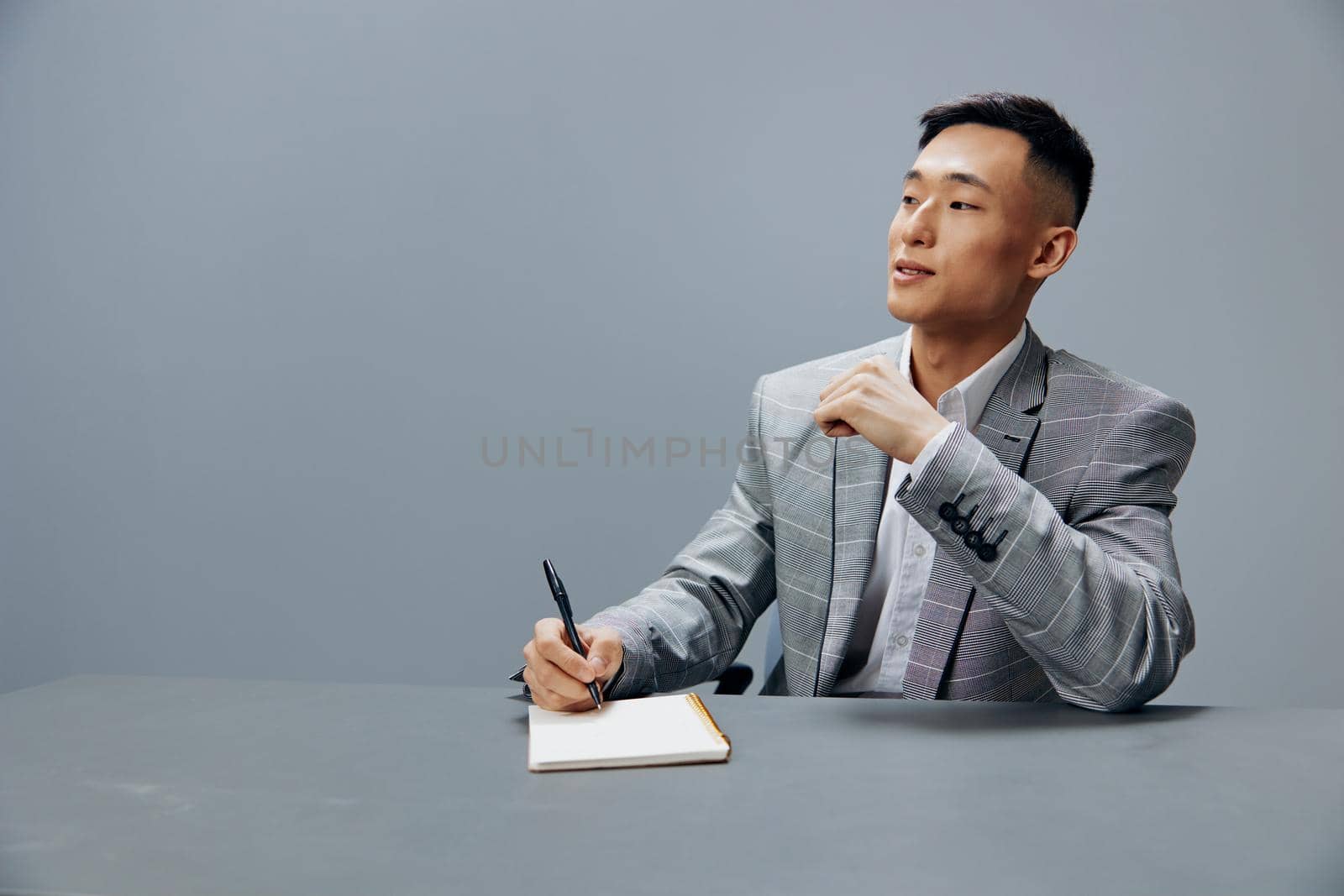 manager with a notepad on the table sits at the office desk executive by SHOTPRIME