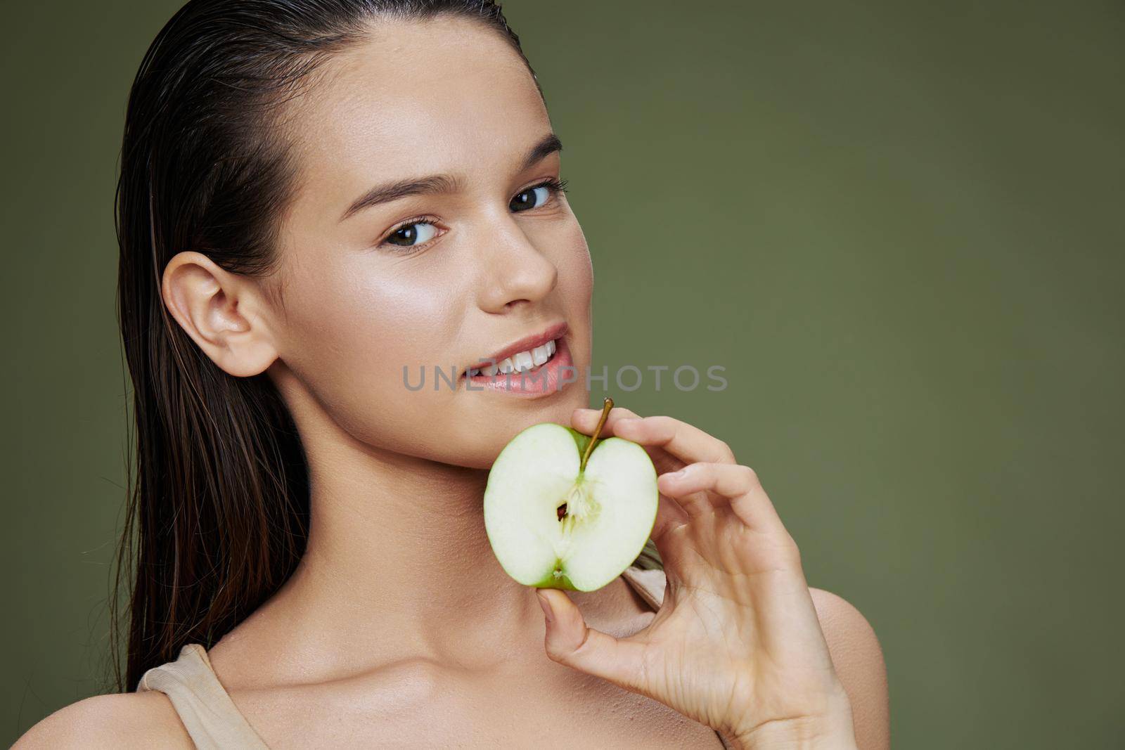 beautiful woman with a green apple smile isolated background. High quality photo