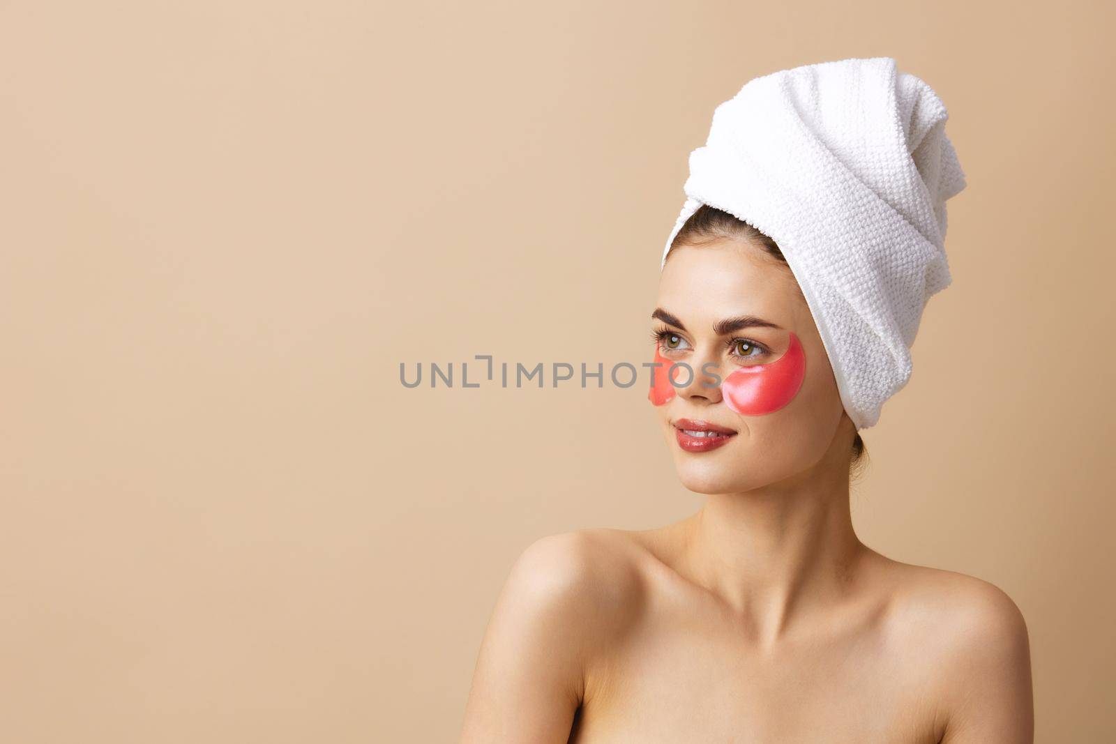 beautiful woman pink patches on the face with a towel on the head close-up Lifestyle by SHOTPRIME