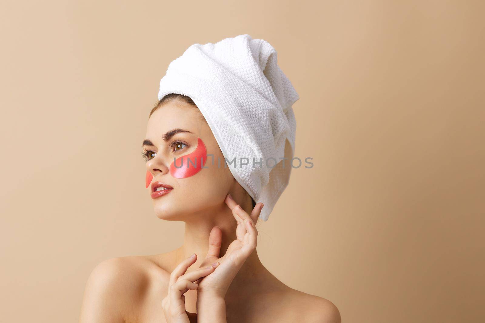 beautiful woman with a towel on his head gesturing with his hands skin care isolated background by SHOTPRIME