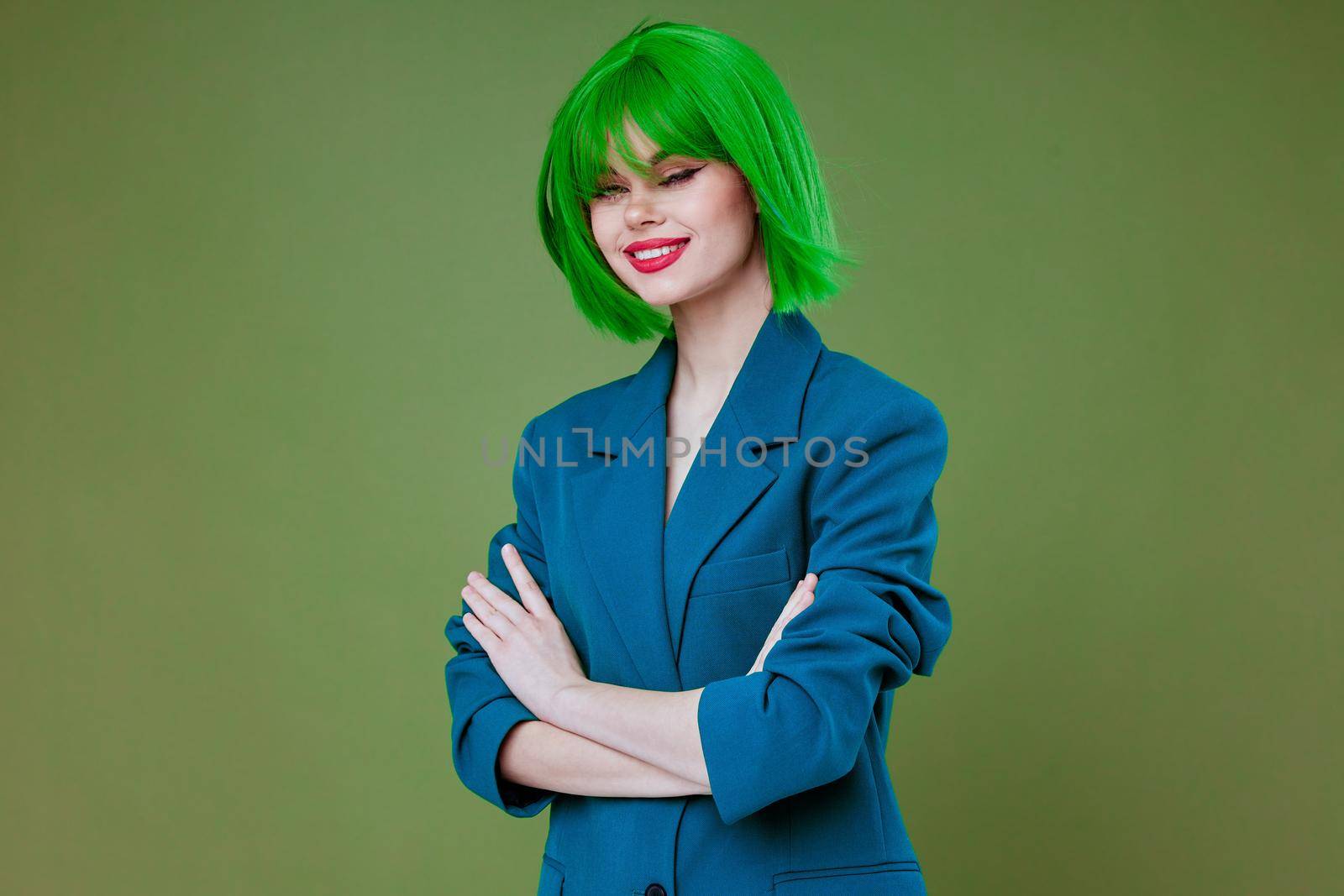 Beauty Fashion woman attractive look green wig blue jacket posing studio model unaltered. High quality photo