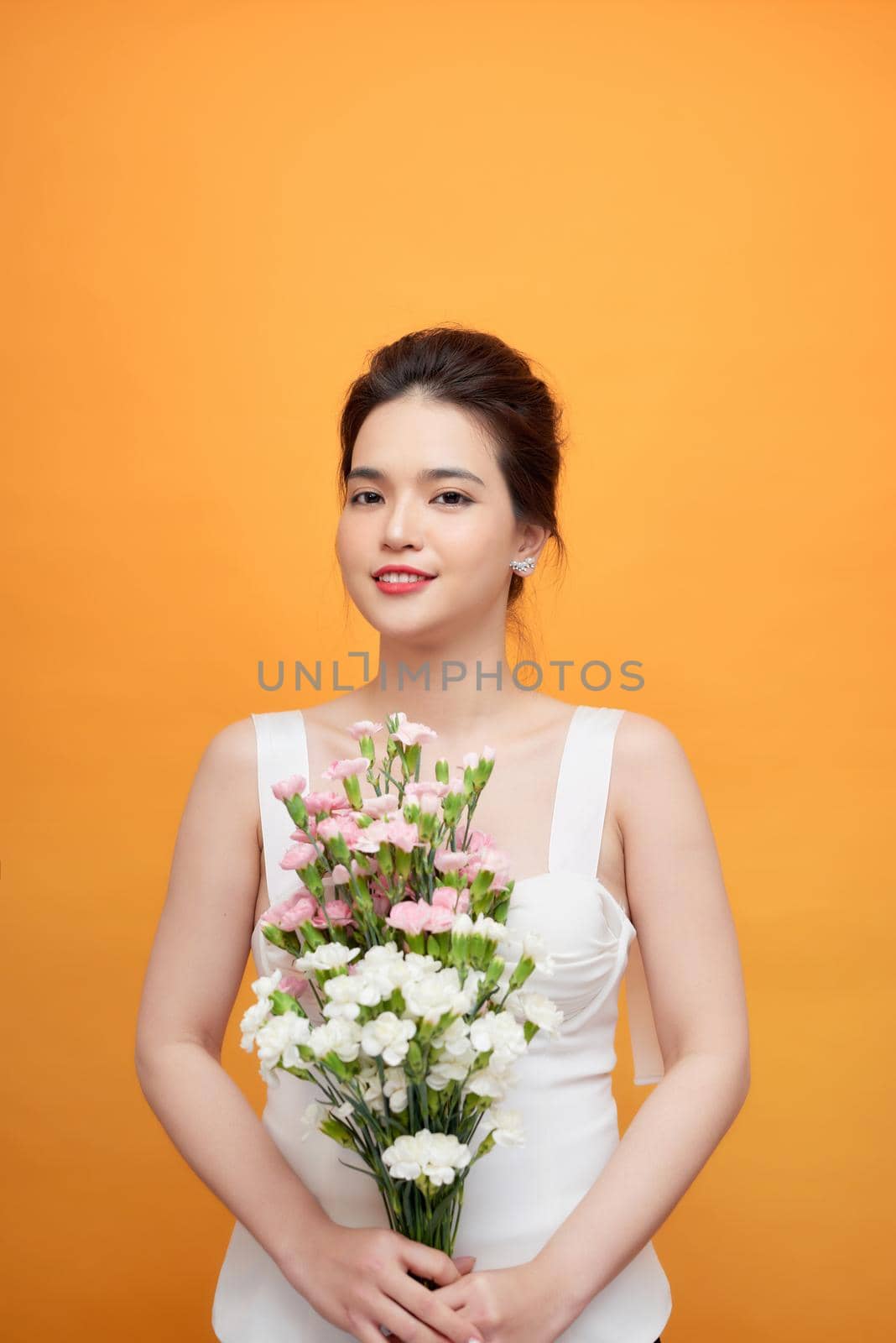 Beautiful woman Cute Asian girl feeling happy holding floral bouquet on yellow background - Beautiful woman lifestyle