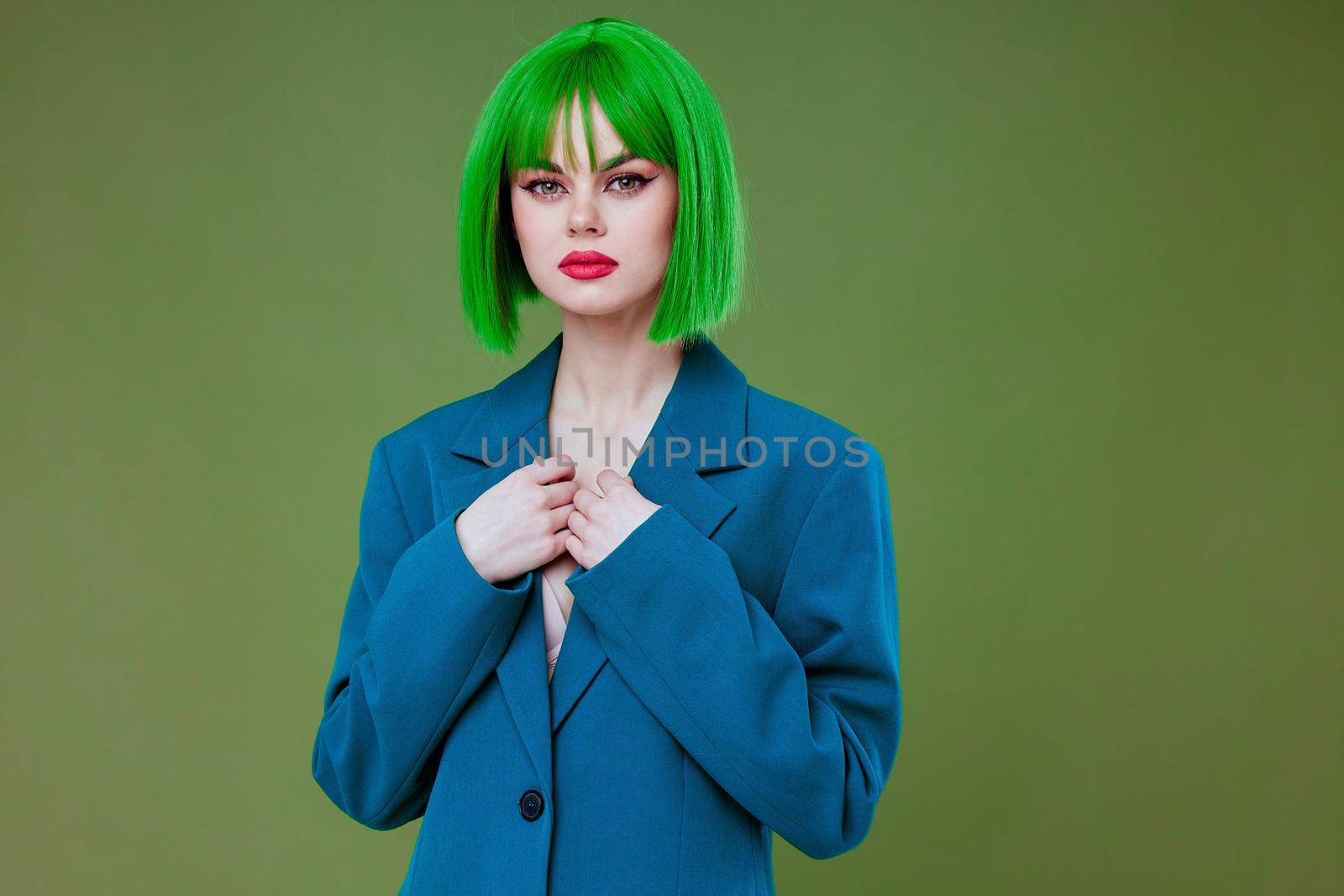 Portrait of a charming lady Glamor green wig red lips blue jacket green background unaltered. High quality photo