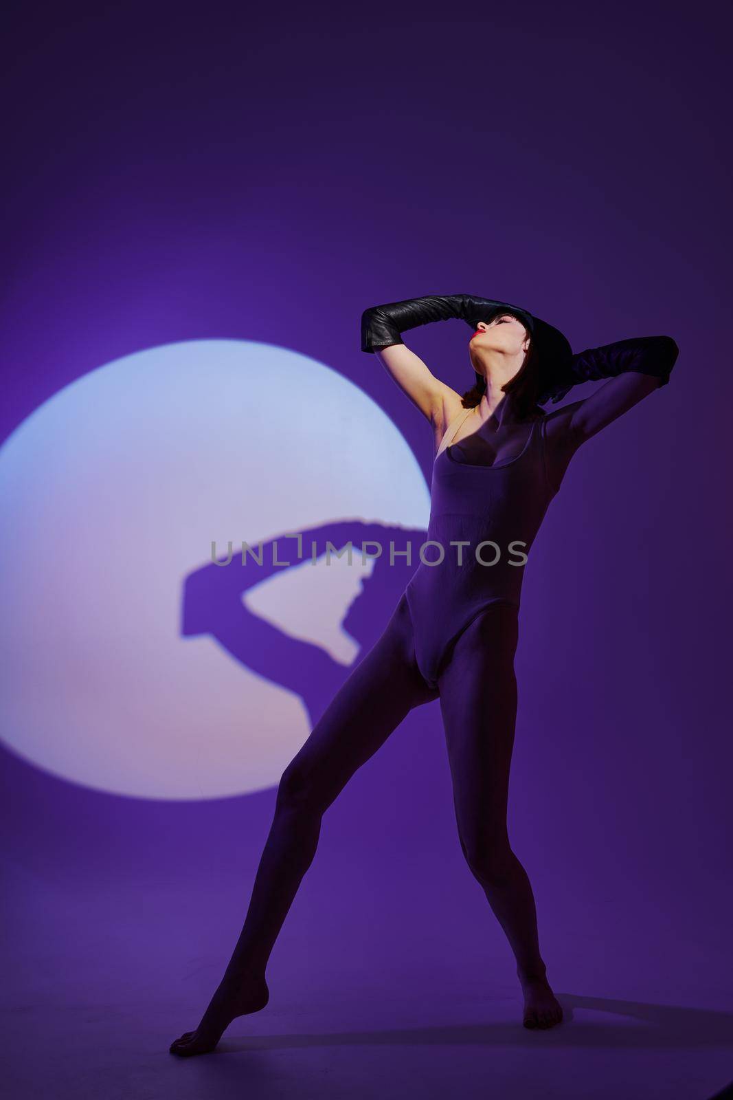 Portrait of a charming lady posing on stage spotlight silhouette disco purple background unaltered. High quality photo