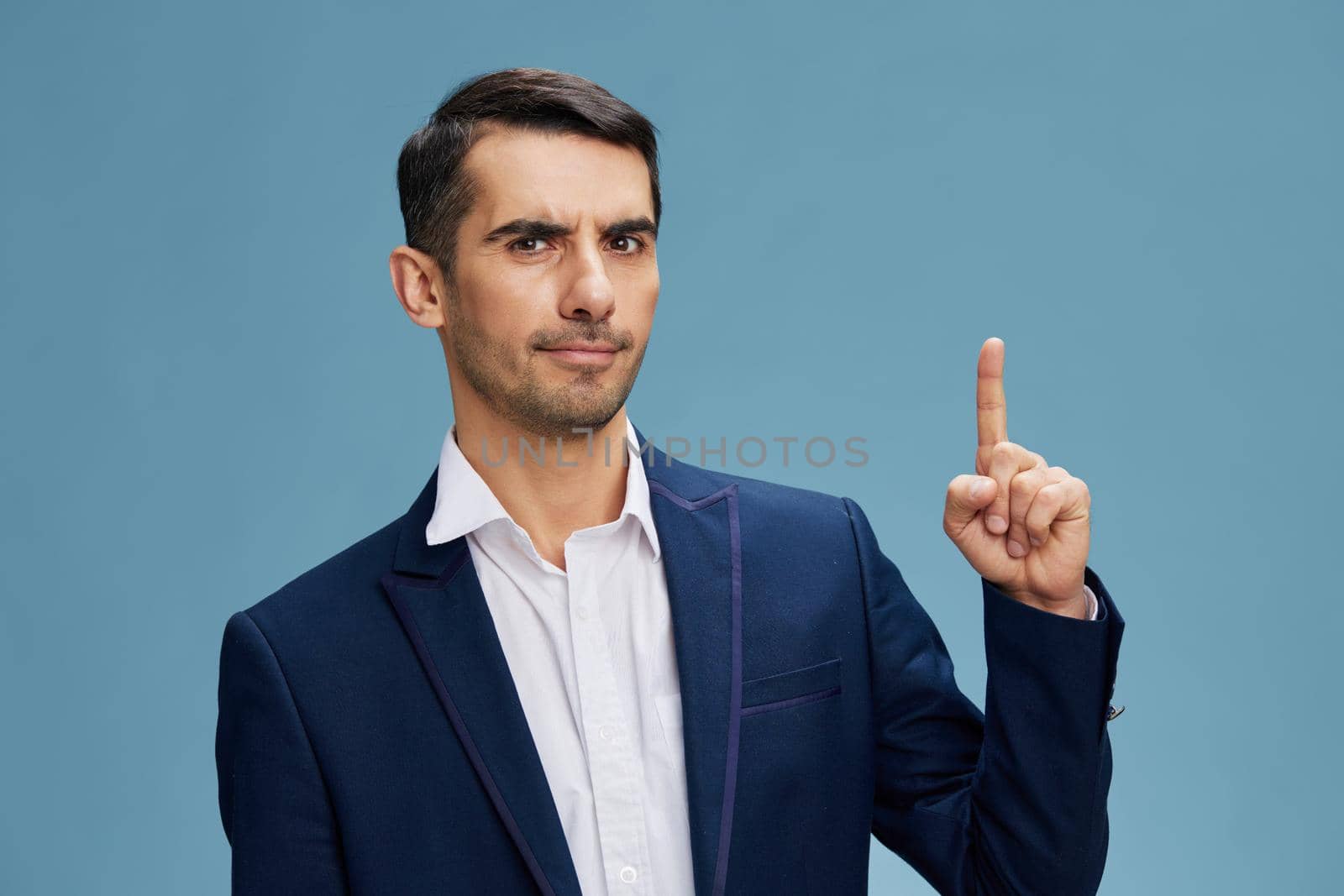 manager showing thumbs up in a modern suit emotion self-confidence official blue background Copy space. High quality photo