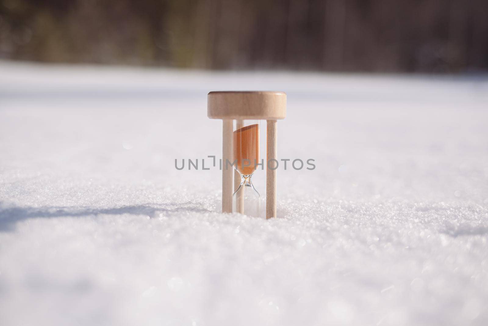 Hourglass in the snow. Spring is coming. melting snow by AnatoliiFoto