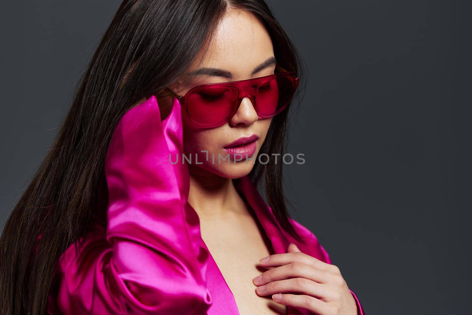 young woman in pink dress red glasses fashion makeup glamor isolated background by SHOTPRIME