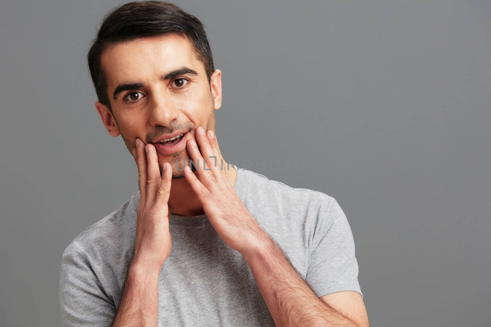 man fun gray t-shirt hand gesture Gray background by SHOTPRIME