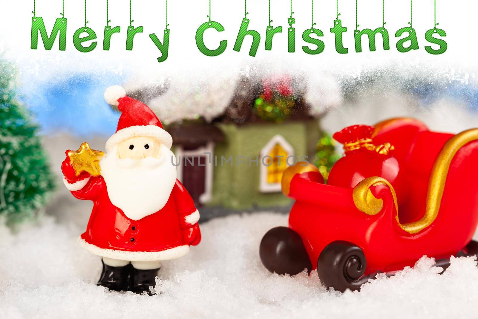 Toy santa claus and sleigh in the snow, artificial fir trees around, christmas greeting card.