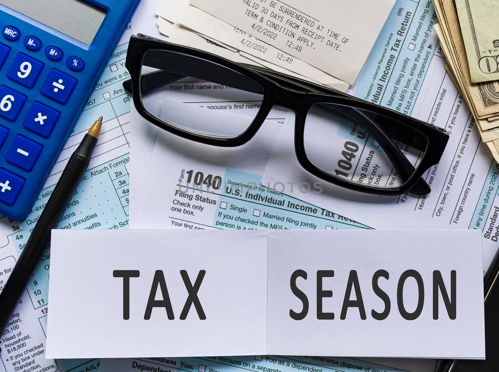 Text on notepad with Tax forms 1040. U.S Individual Income Tax Return on a desk. Business and tax concept. Time to pay tax in year.