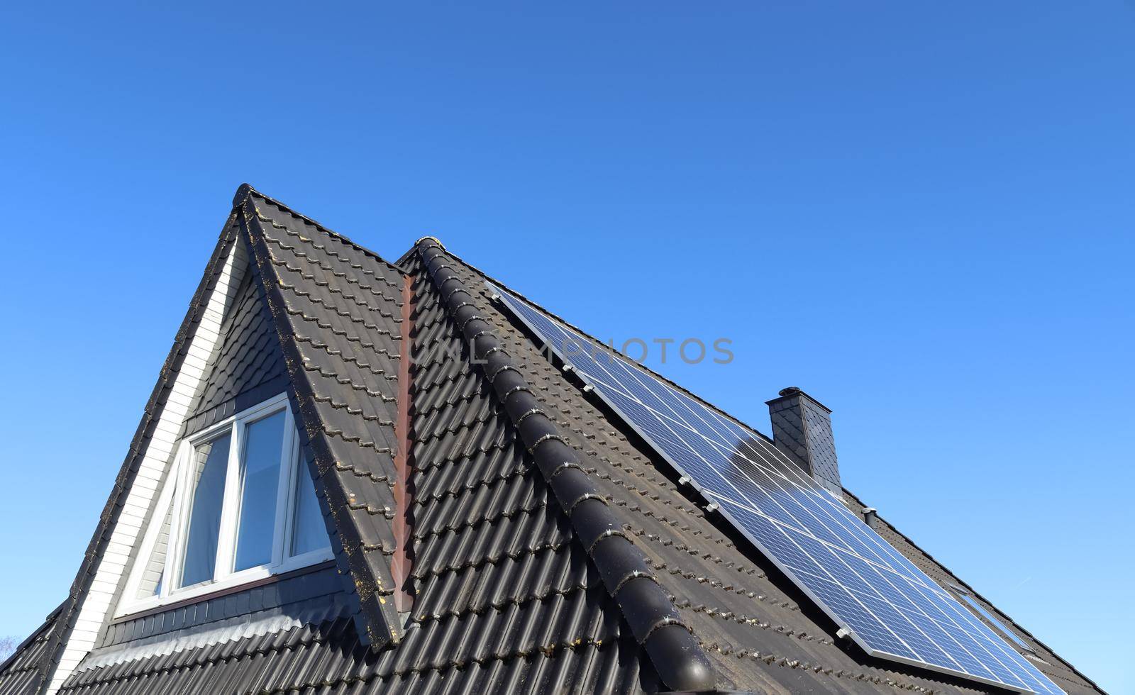 Solar panels producing clean energy on a roof of a residential house