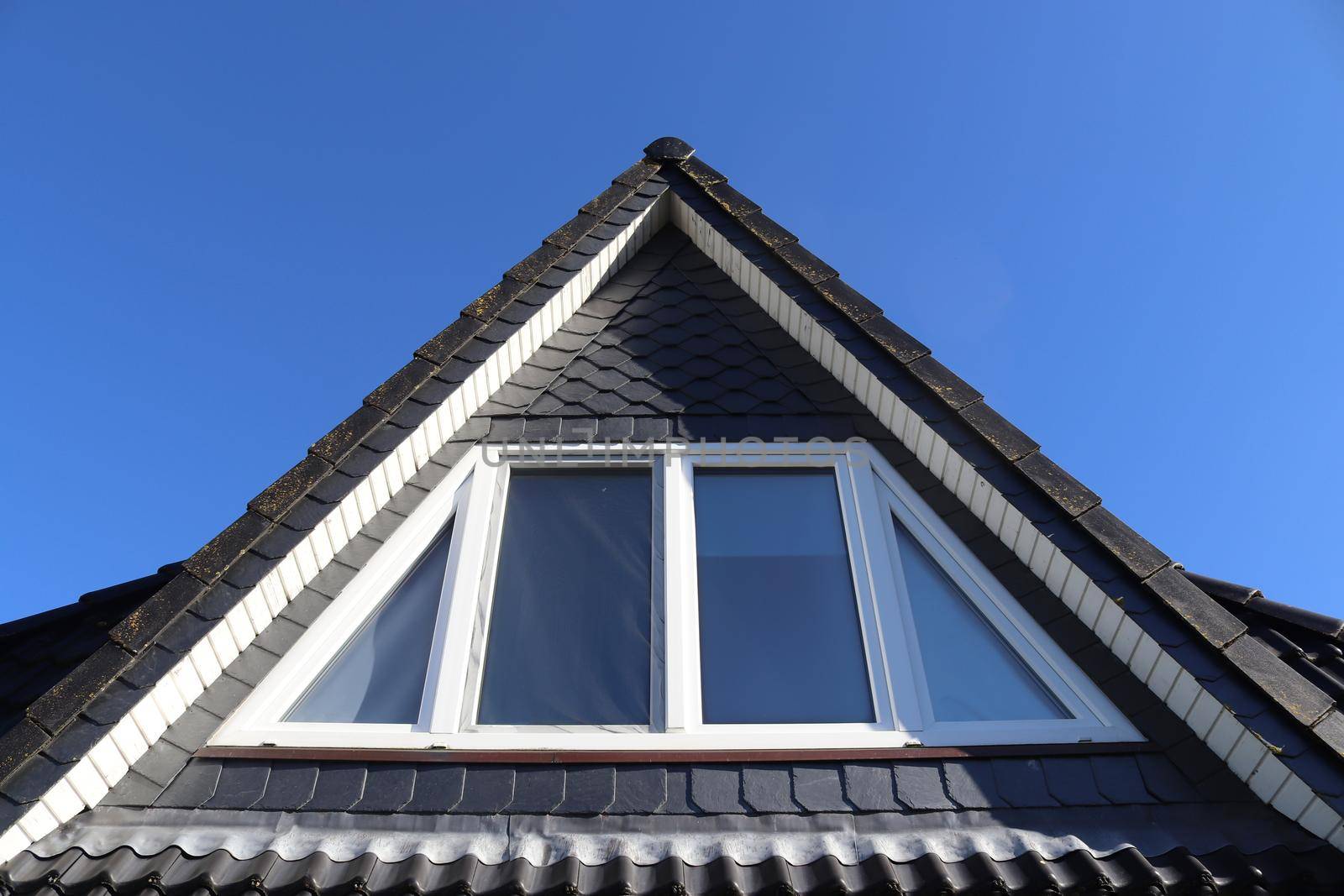 Open roof window in velux style with black roof tiles. by MP_foto71