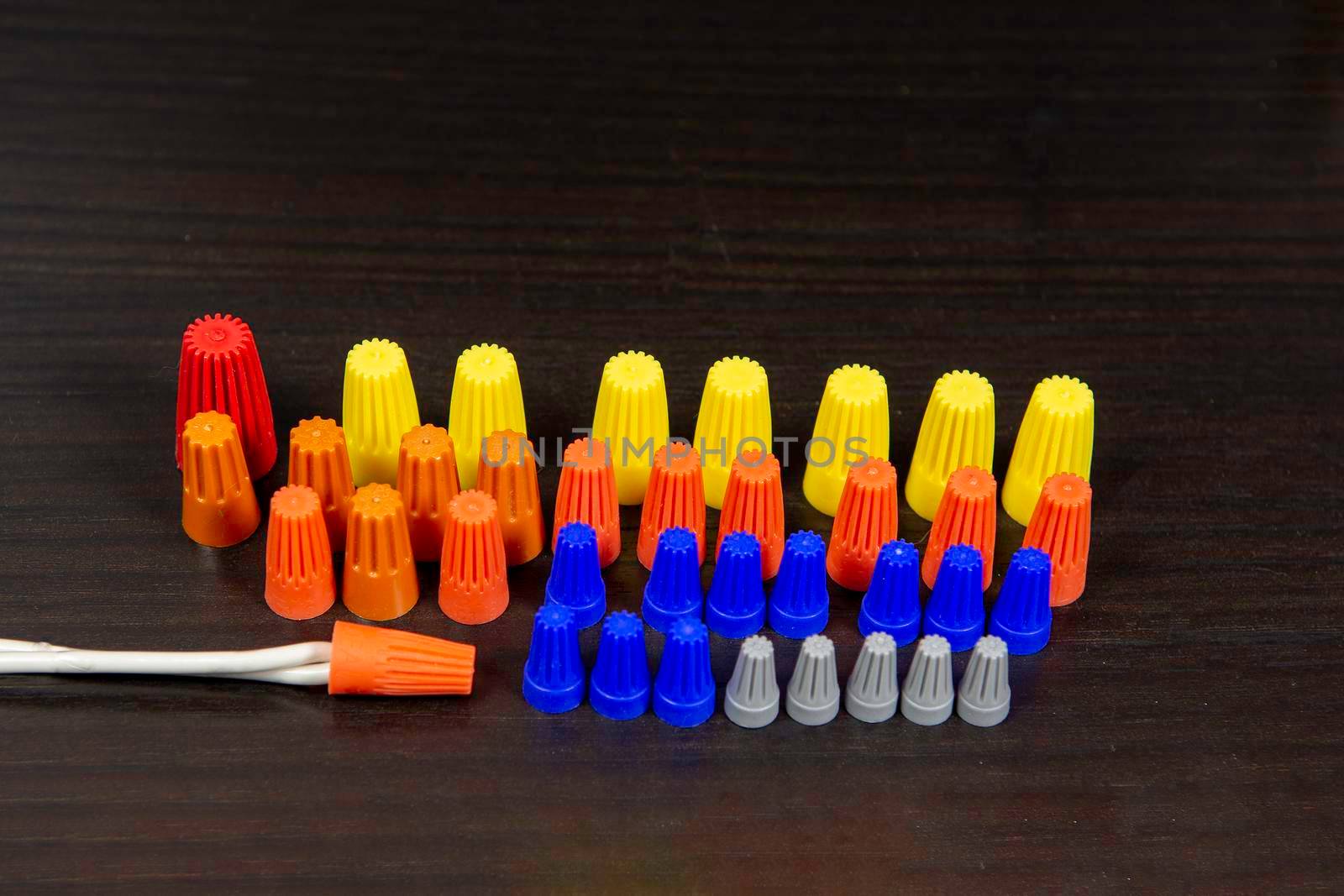 Insulator caps in different colors and sizes for bare ends of twisted wires and stranded wires