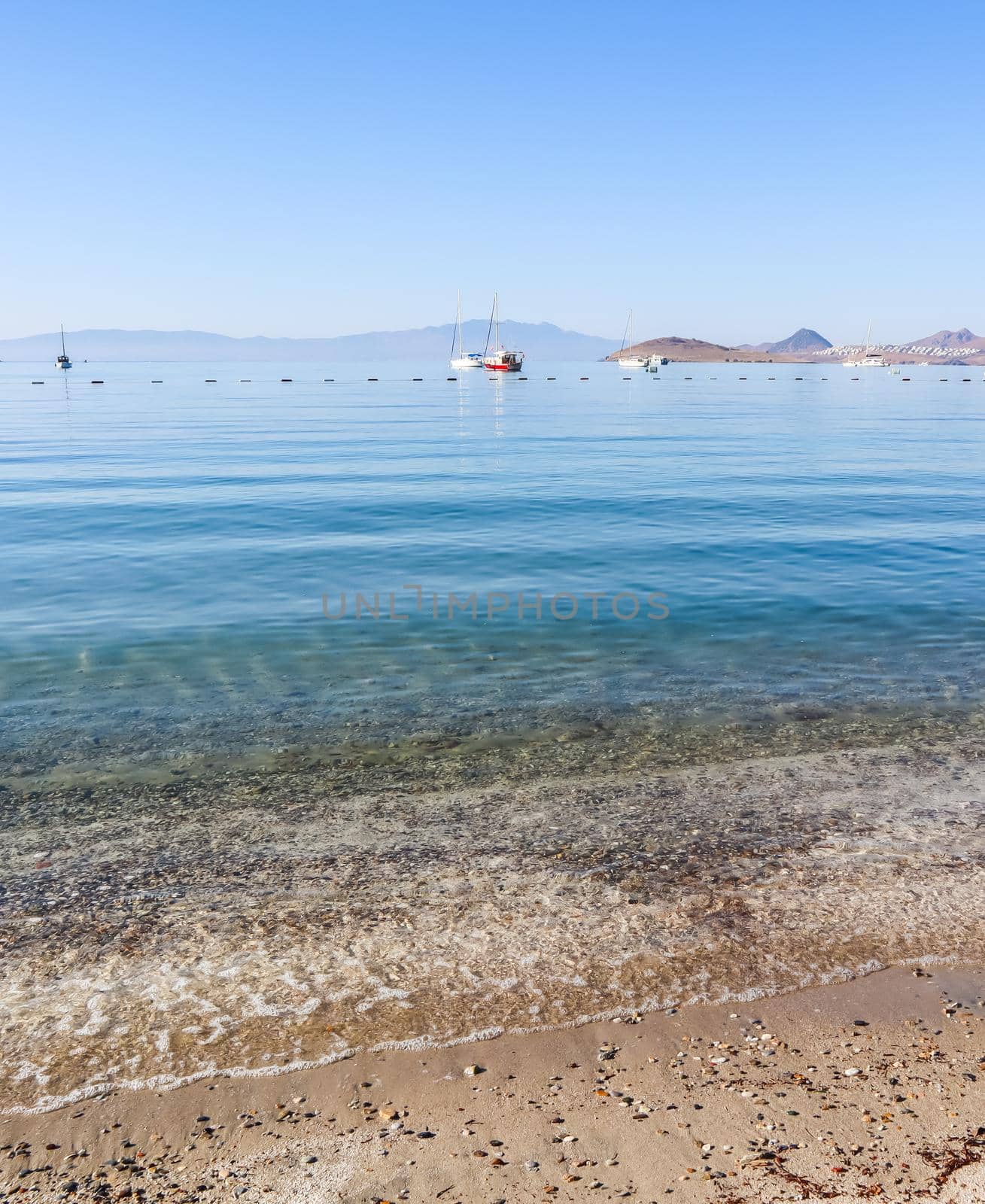 Beautiful calm blue bay with sand beach in Mediterranean. Holiday and relaxation on sea coast