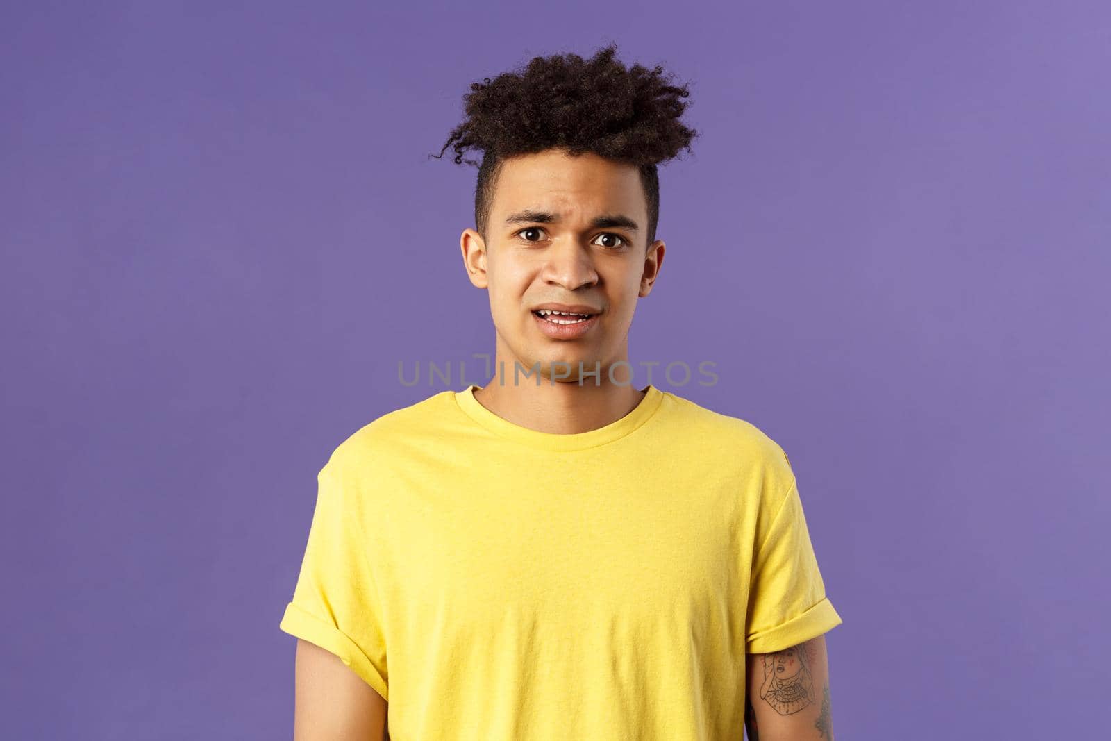 Waist-up portrait of young concerned hispanic man with worried gaze looking at camera, frowning being scared for friend stuck in troublesome situation, want help, stand purple background by Benzoix