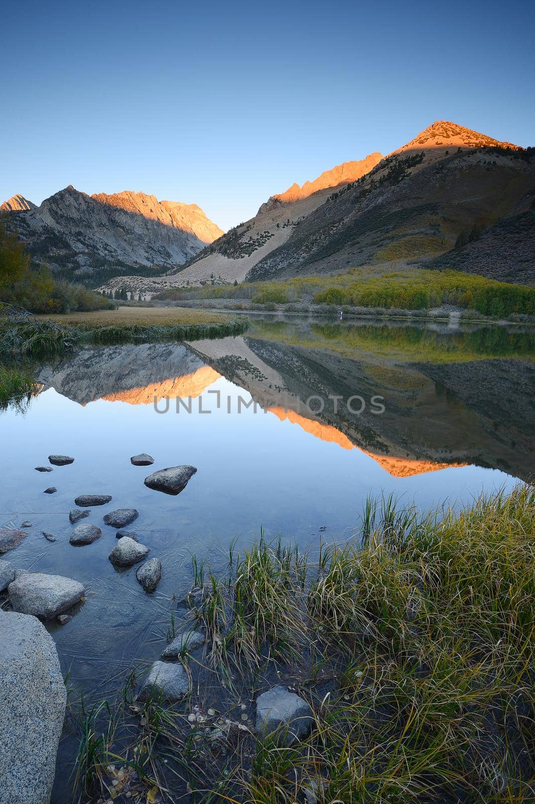 morning sunlight over mountain behind north lake at sierra nevada range