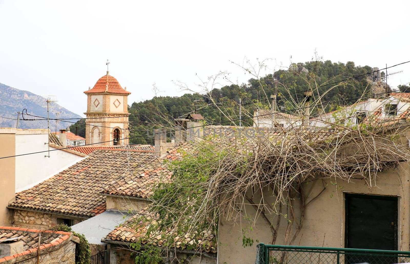 Beautiful view of Benifato village with its church tower surrounded by vegetation and the mountains