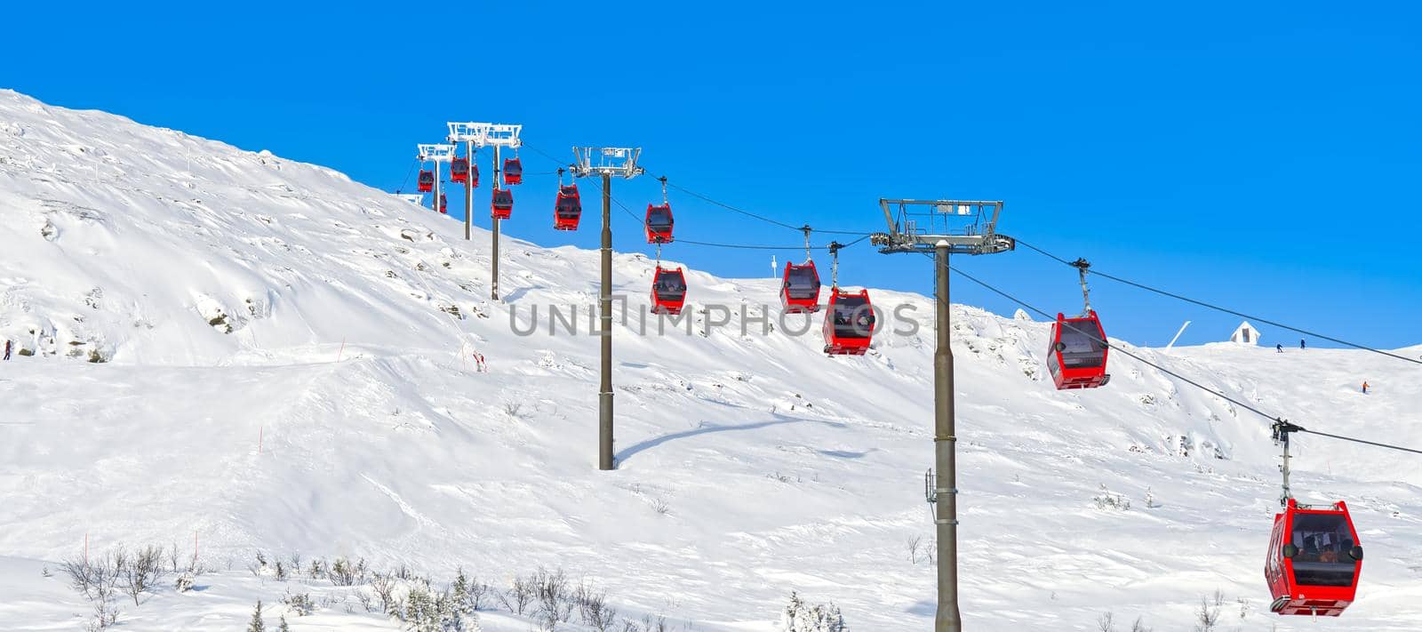 Red cable car in a ski resort in the Alps. Red gondola funicular in a ski resort, sweden, frosty sunny day by PhotoTime
