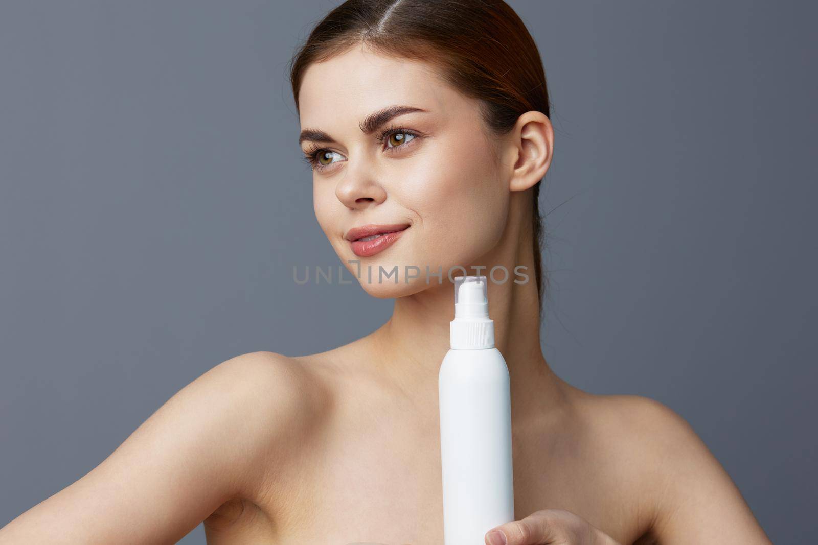 portrait woman lotion jar clean skin health care Gray background. High quality photo