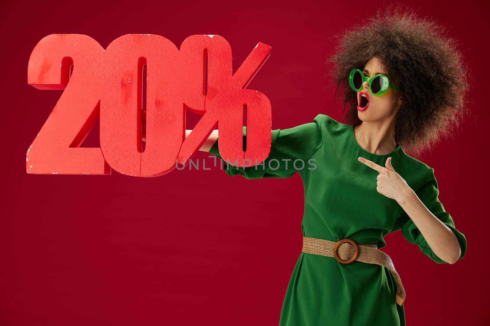 Beautiful fashionable girl curly hairstyles green dress twenty percent discount color background unaltered by SHOTPRIME