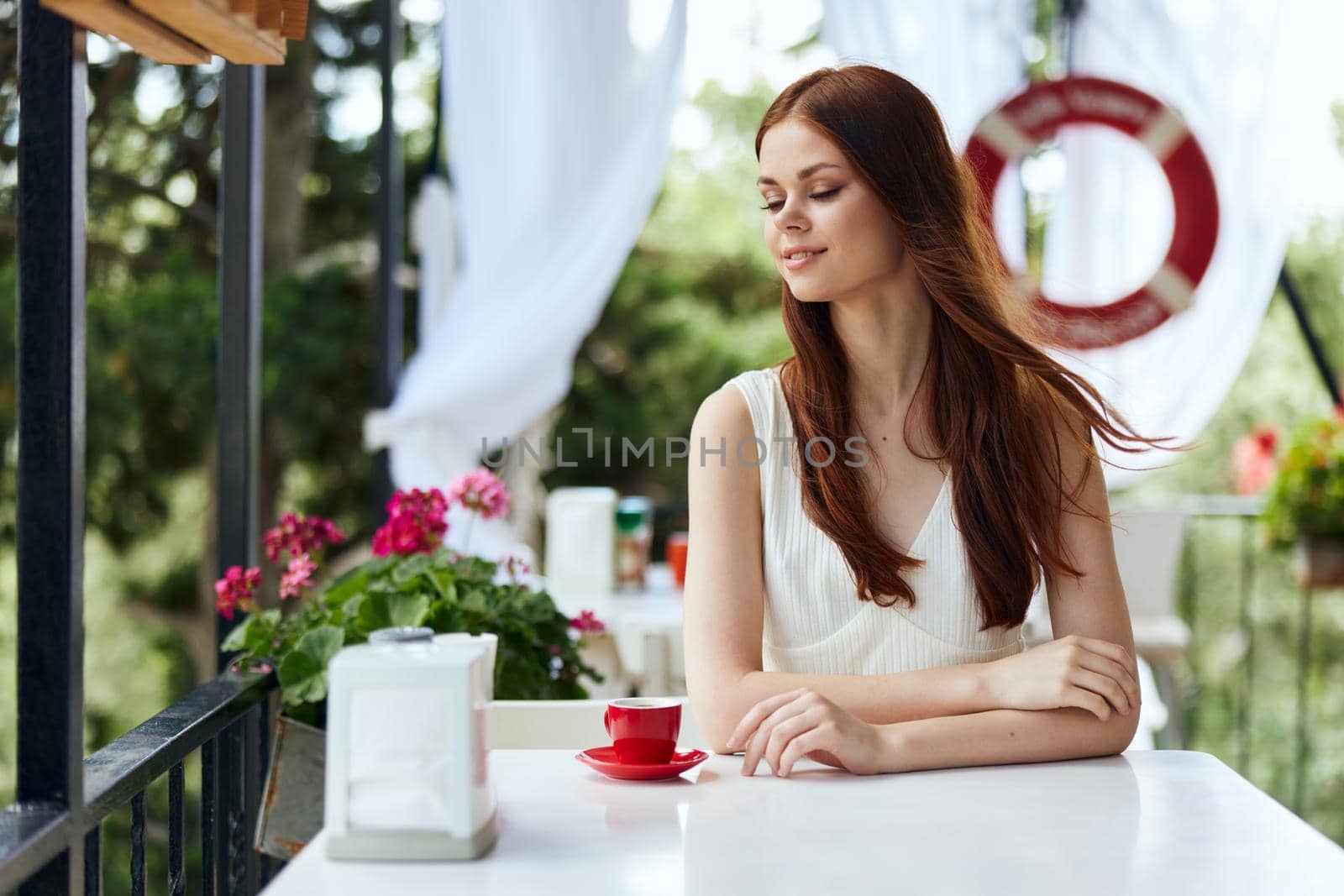 beautiful woman holding a coffee cup standing in the park at summer Relaxation concept by SHOTPRIME