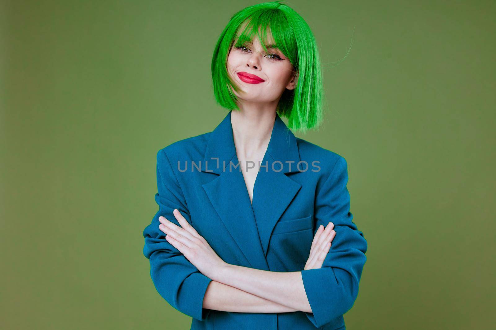 Positive young woman Glamor green wig red lips blue jacket studio model unaltered by SHOTPRIME
