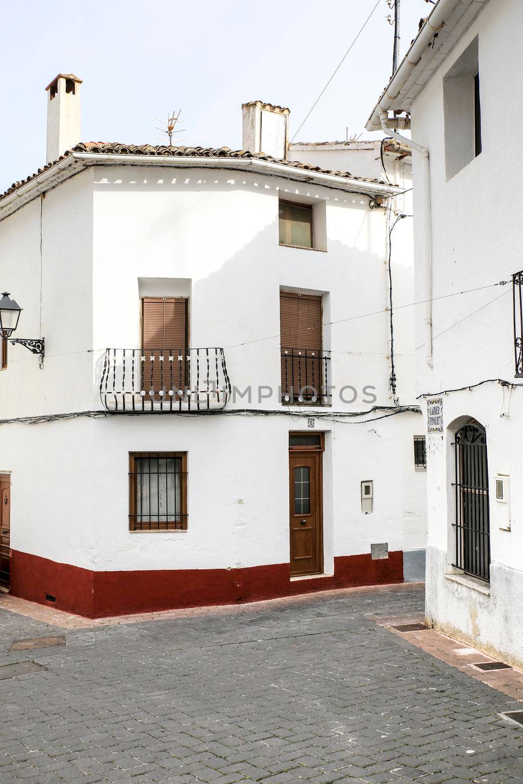 Bolulla, Alicante, Spain- February 4, 2022: Narrow Street and typical facades of Bolulla village in Alicante, Spain