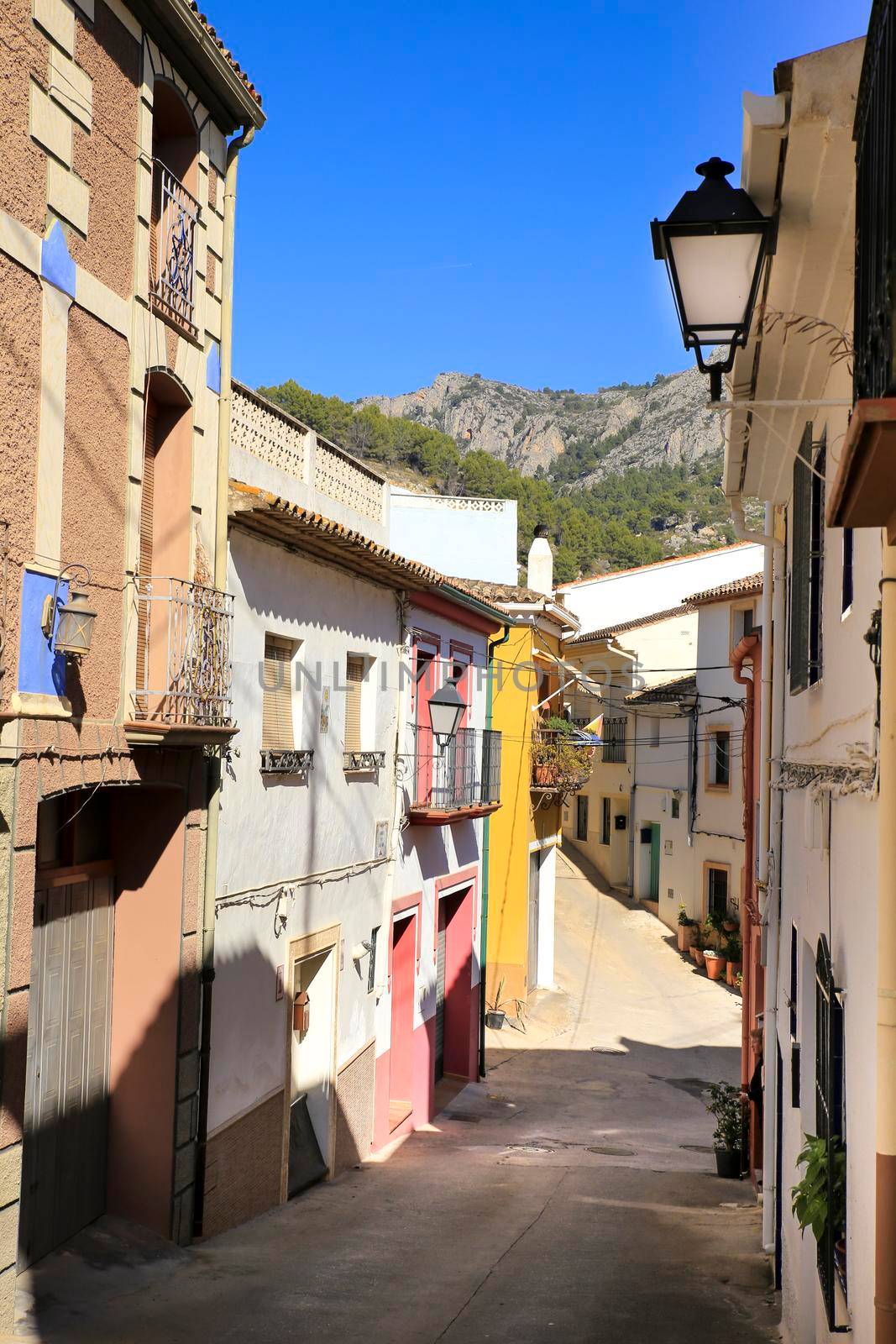 Bolulla, Alicante, Spain- February 4, 2022: Narrow Street and typical facades of Bolulla village in Alicante, Spain