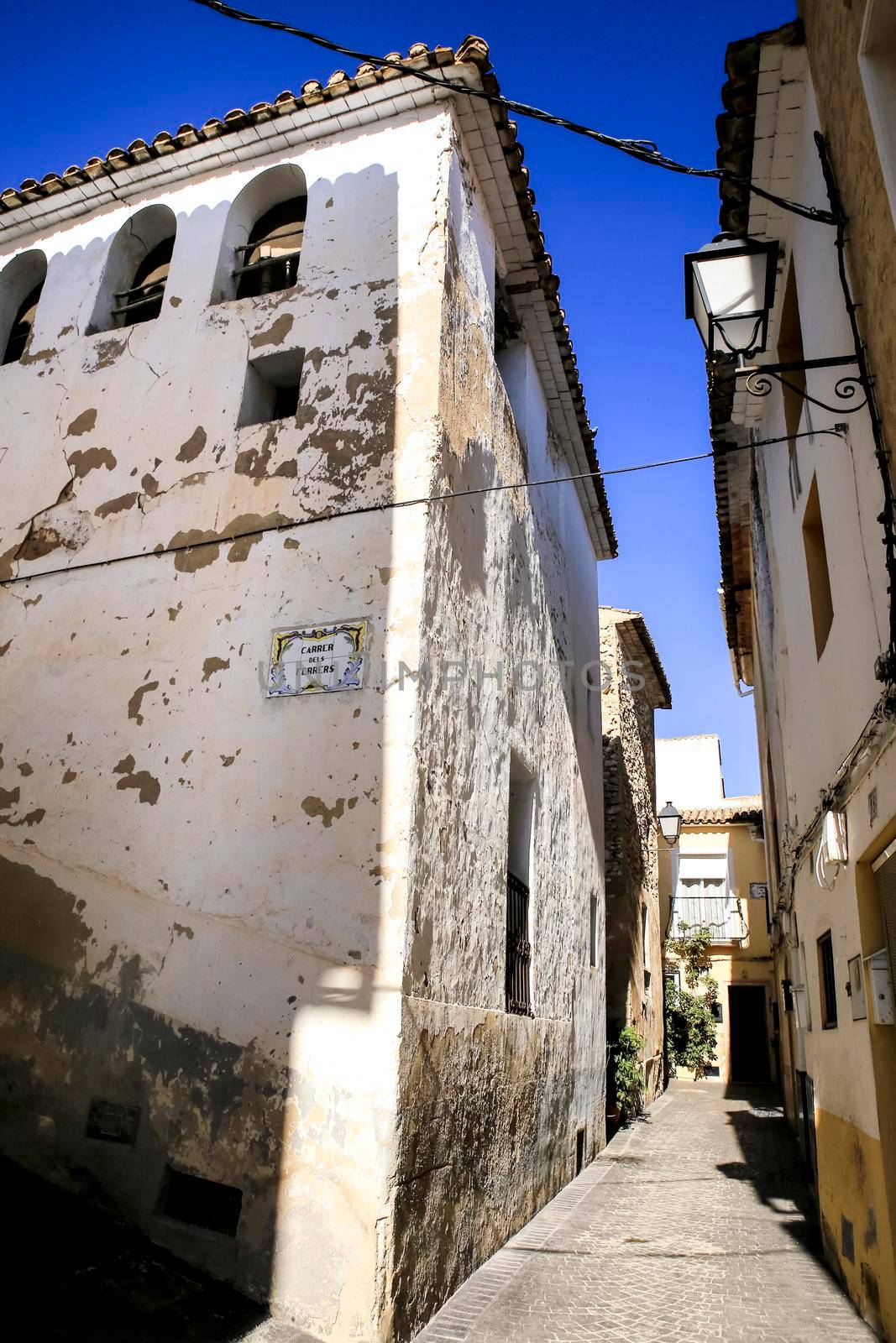 Bolulla, Alicante, Spain- February 4, 2022: Narrow Street and typical facades of Bolulla village in Alicante, Spain