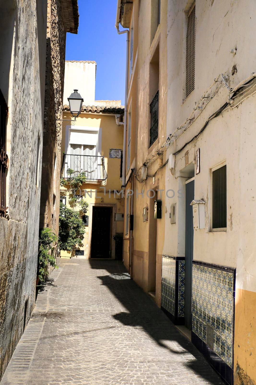 Bolulla, Alicante, Spain- February 4, 2022: Narrow Street and typical facades of Bolulla village in Alicante, Spain