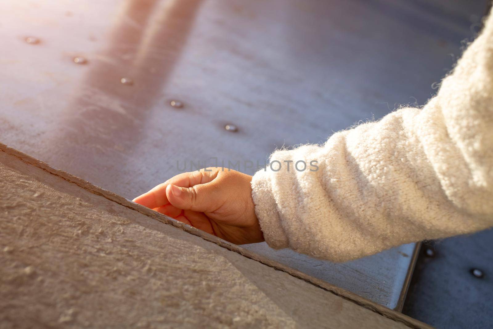 baby hand touch beton on sidewalk close up by Mariaprovector