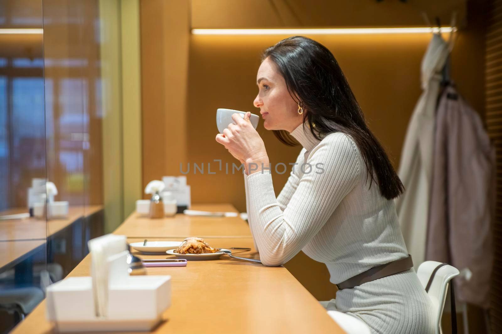 Woman enjoying a cup of coffee in cafe