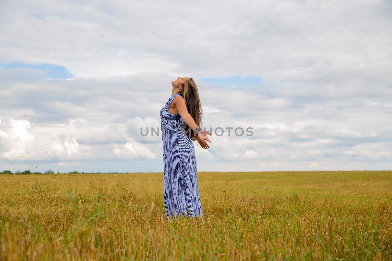 woman dance in summer field. feeling of freedom and happiness by Mariaprovector