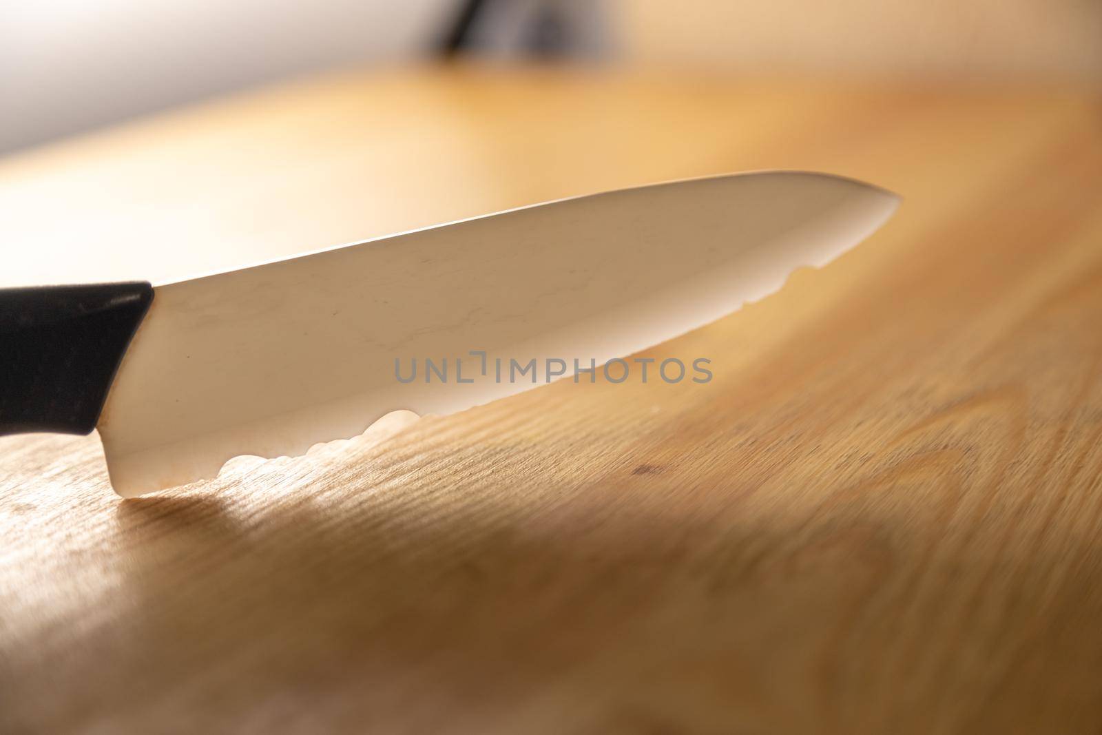 old broken ceramic knife lies on wooden table