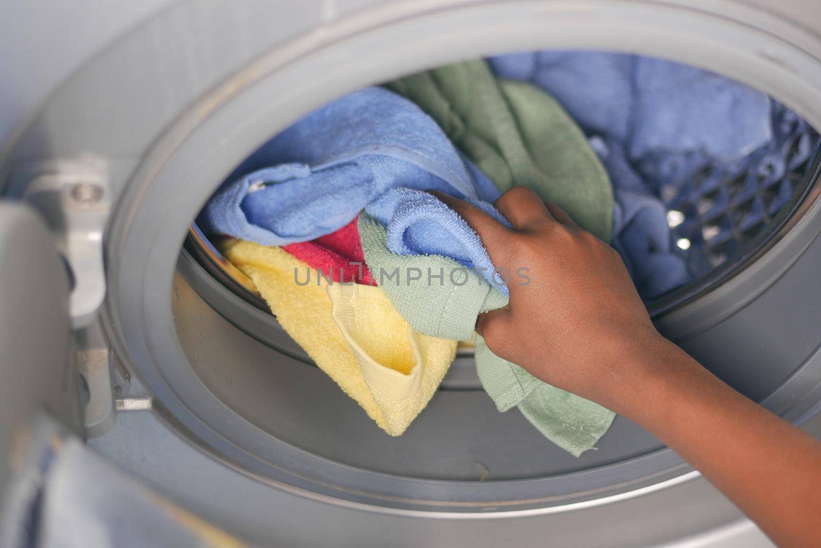 putting towel and cloths in a washing machine